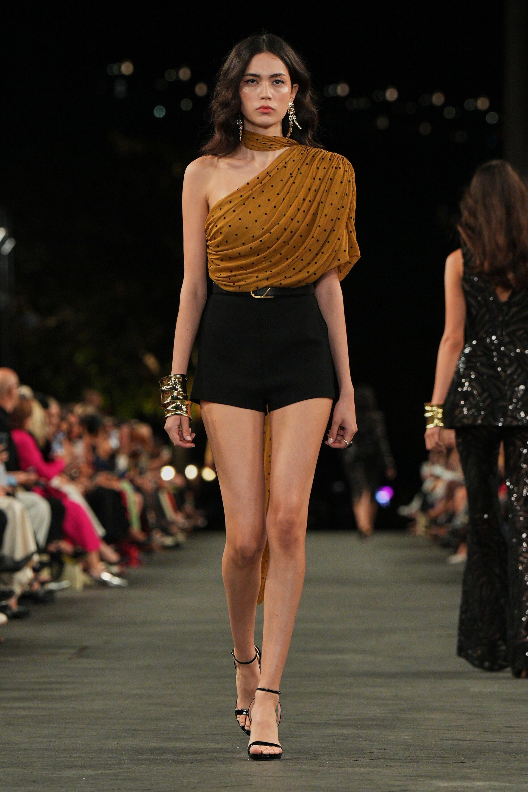 brown draped one-shoulder top with black shorts