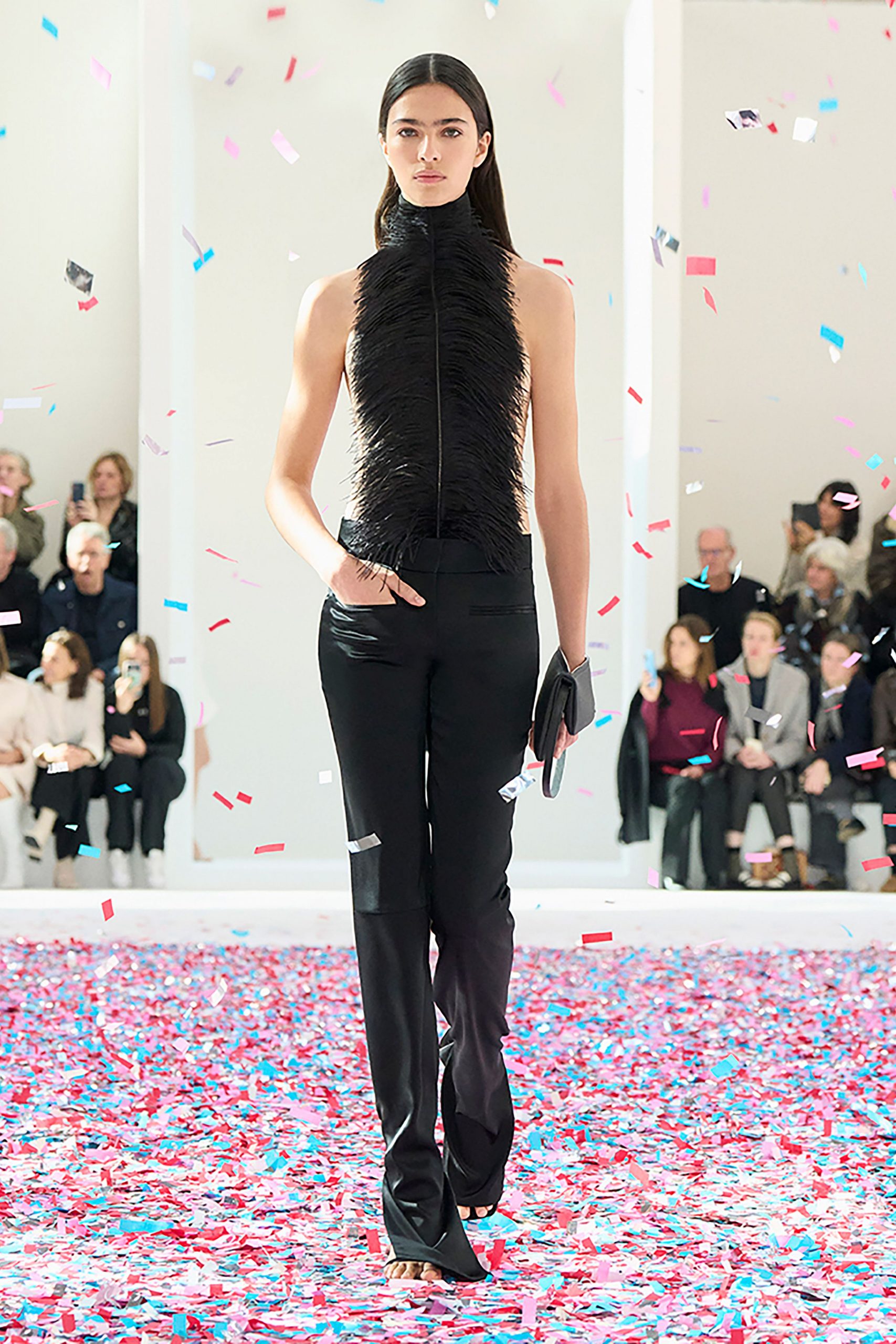 black fringed sleeveless top with slim pants