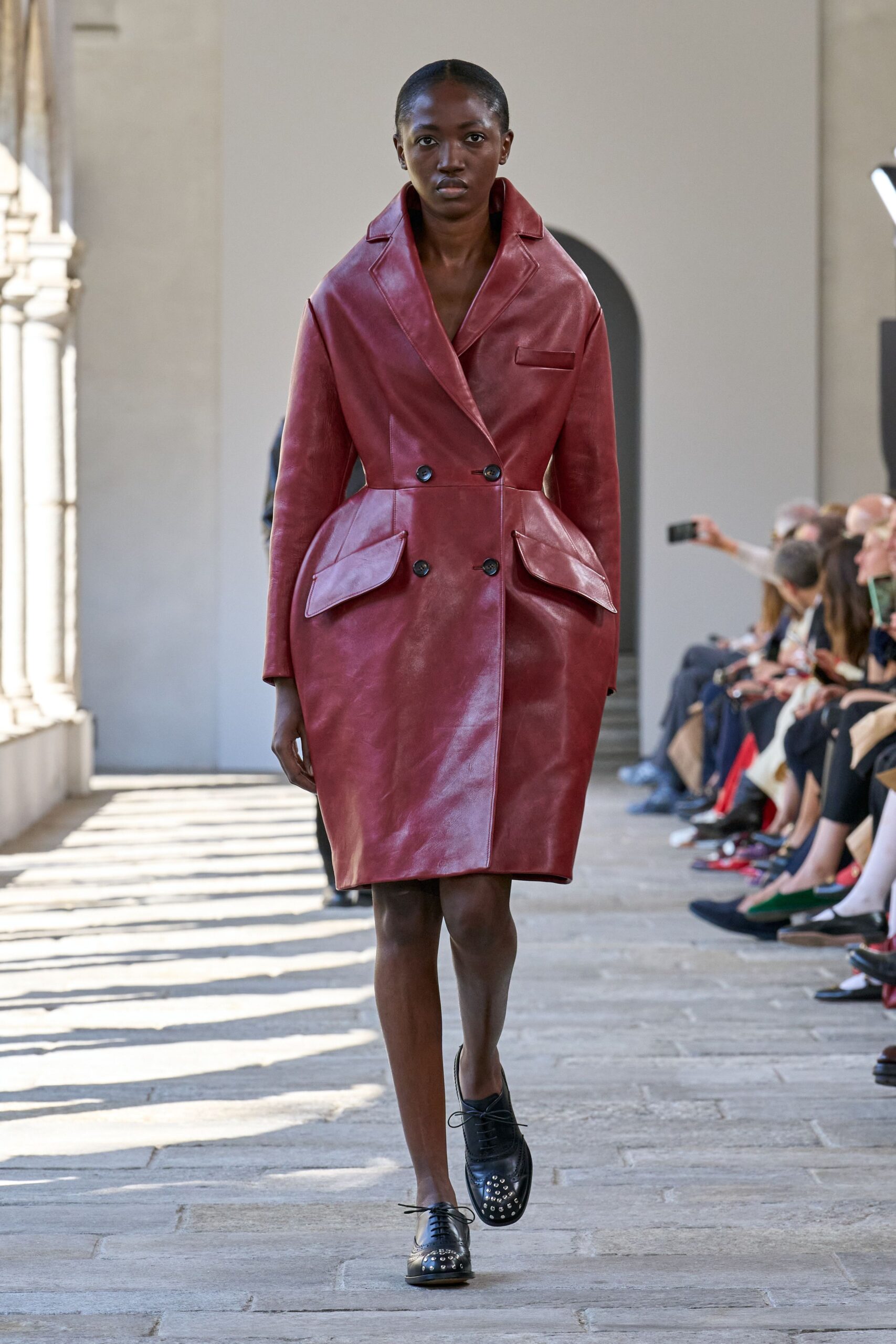 red leather long-sleeve collared fitted pockets coat