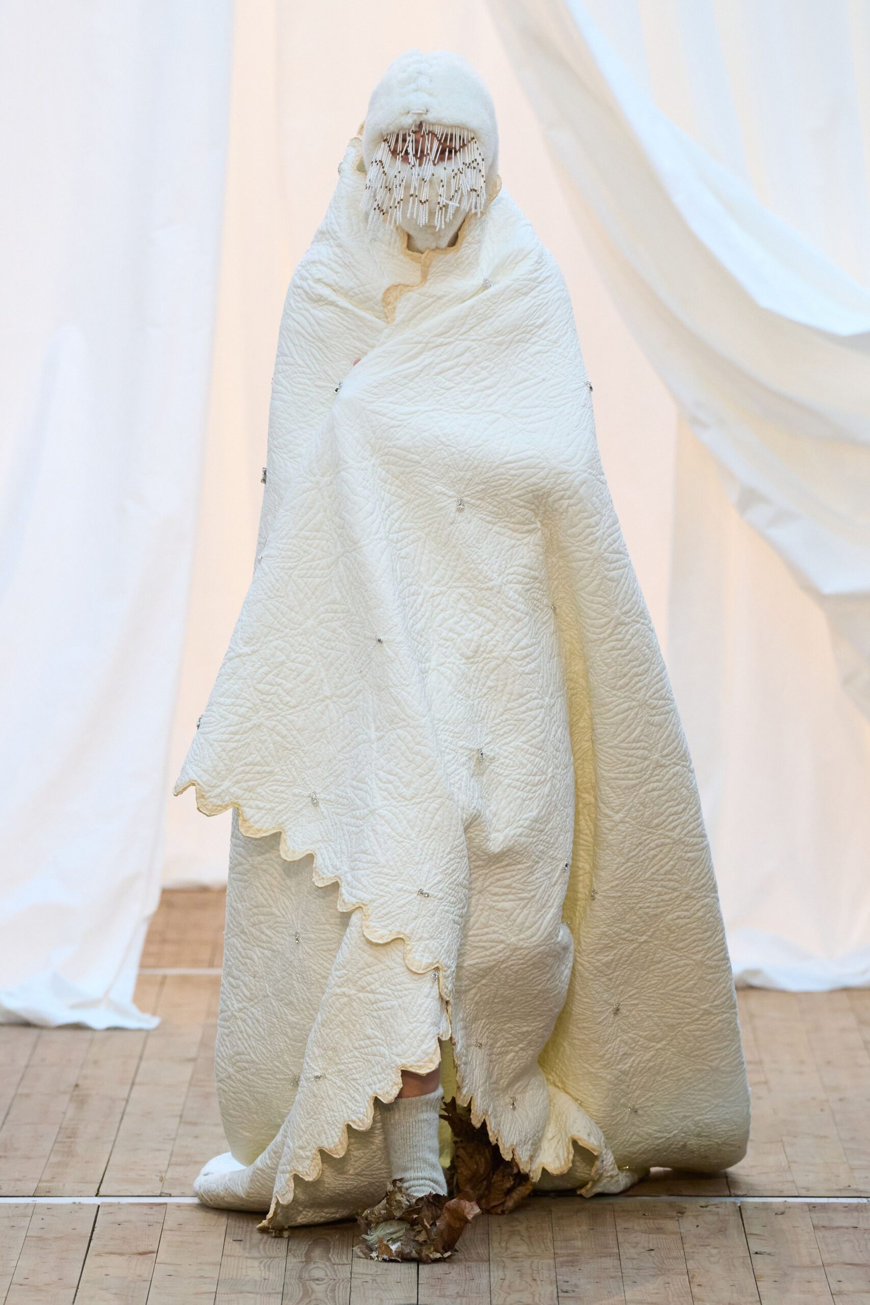 white pleated cape with brown shoes