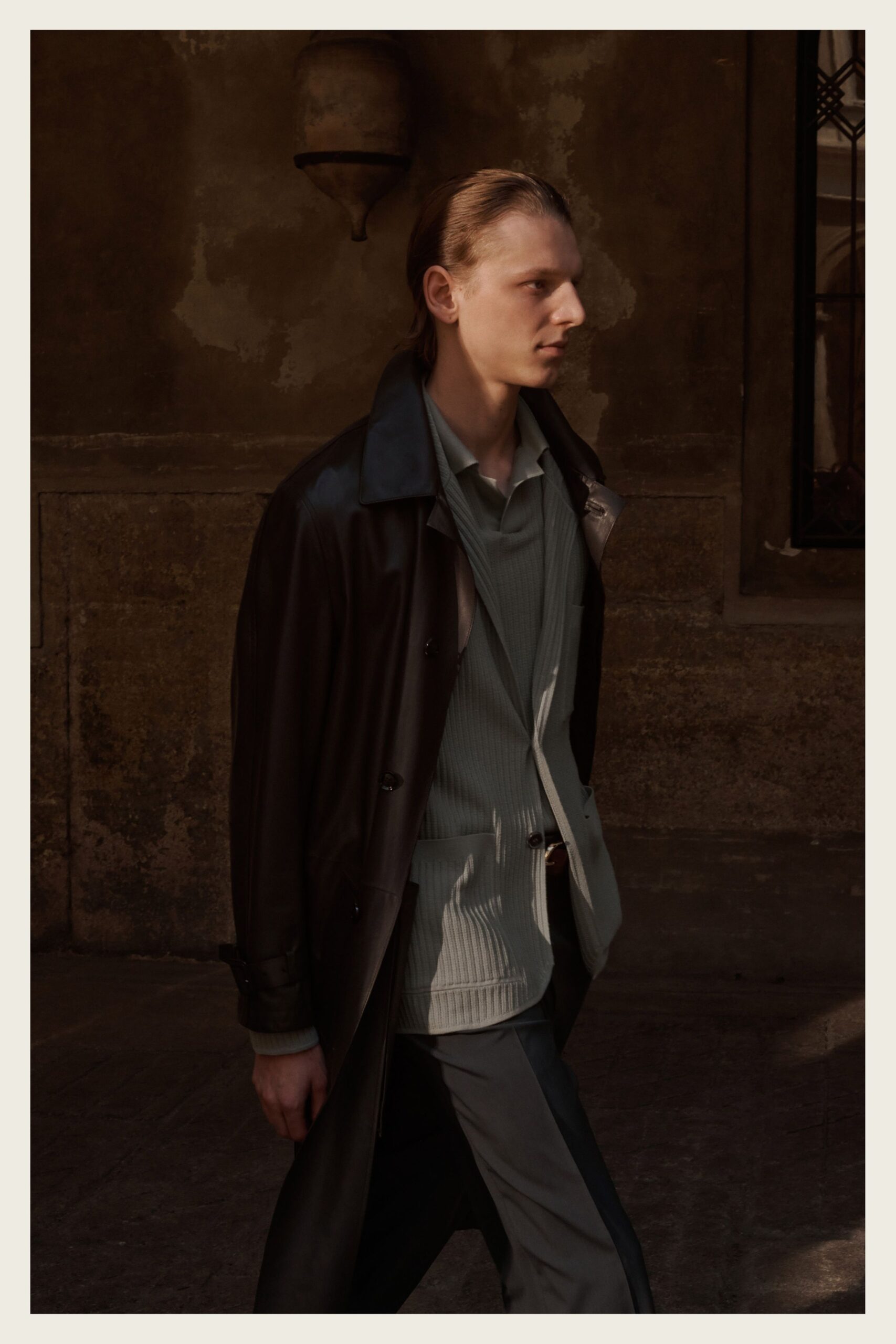 black leather long-sleeve collared oversized buttoned shiny coat