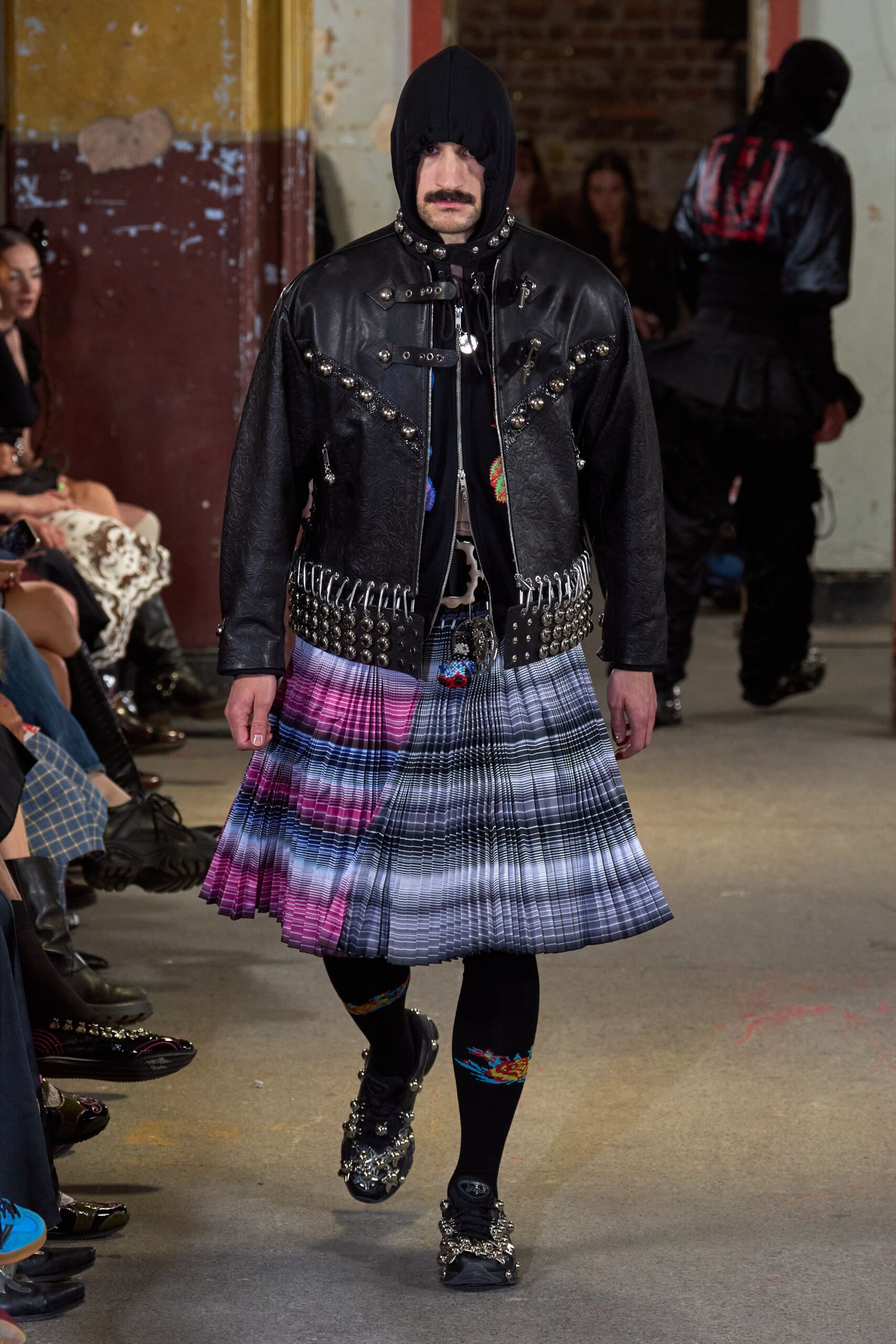 black leather jacket with pleated skirt