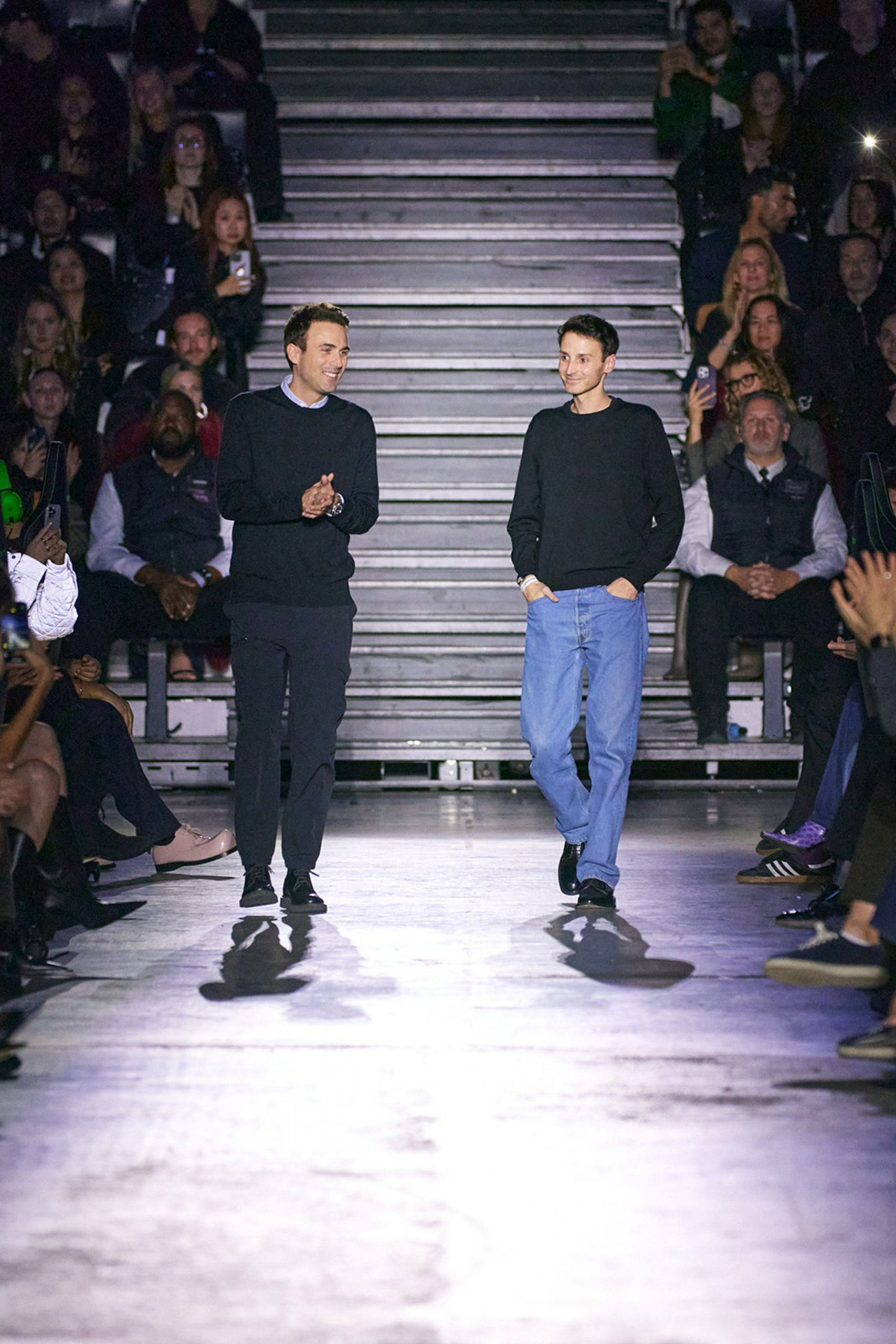 black sweater and blue jeans