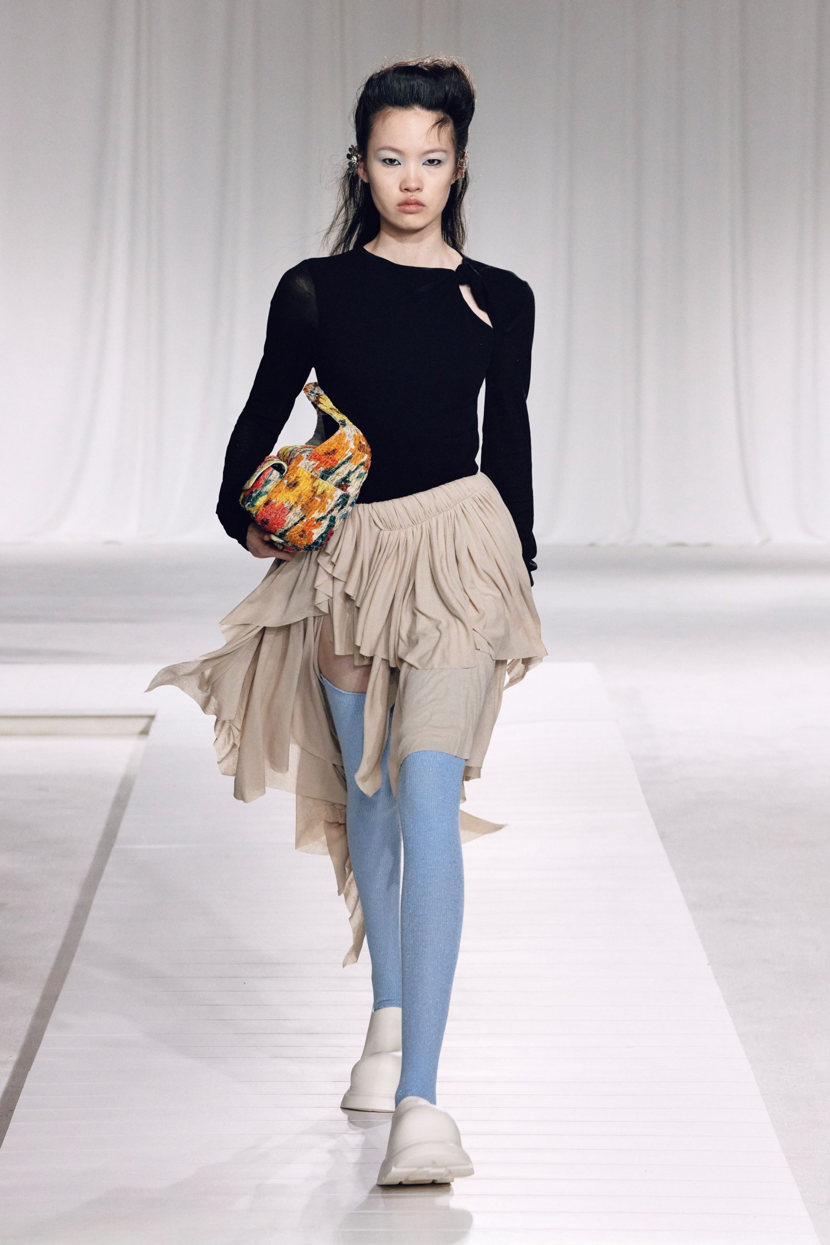 black top beige skirt blue pants