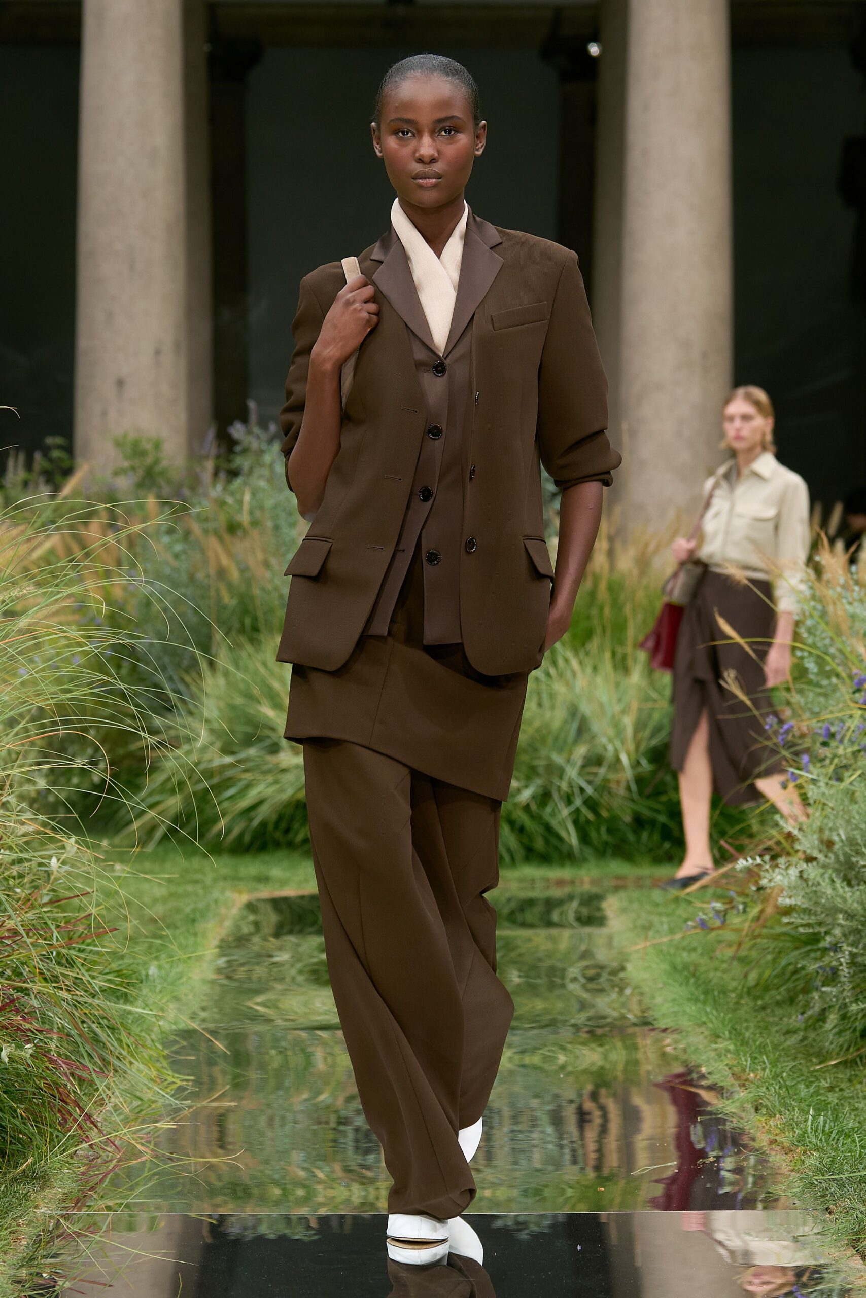 brown tailored suit with white shoes