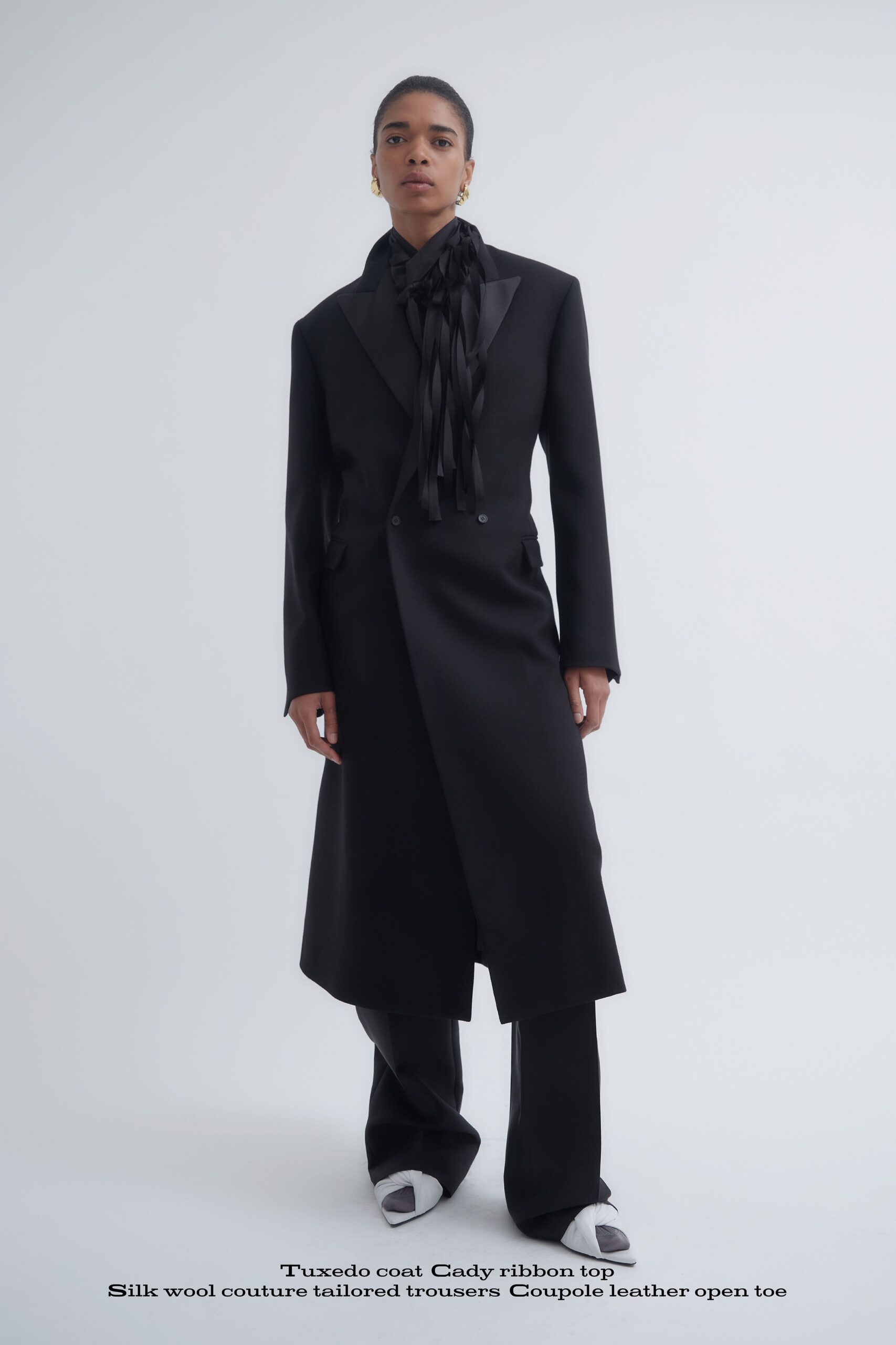 black tailored coat and trousers