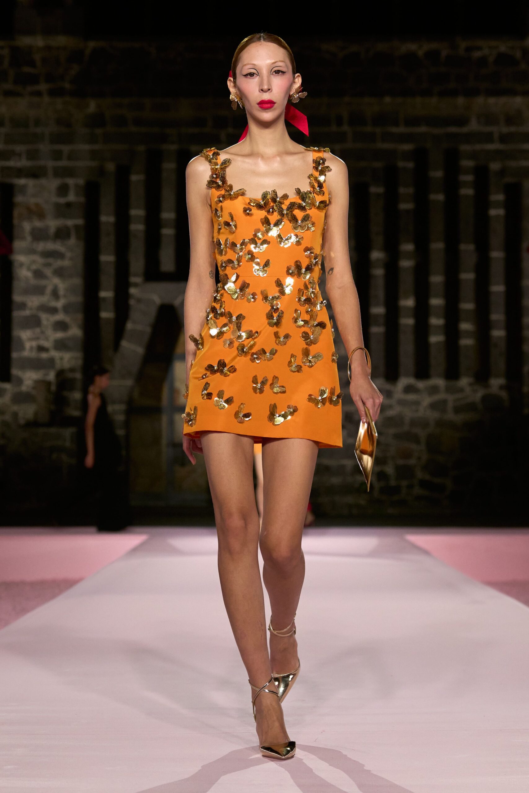 orange mini-dress with gold accessories