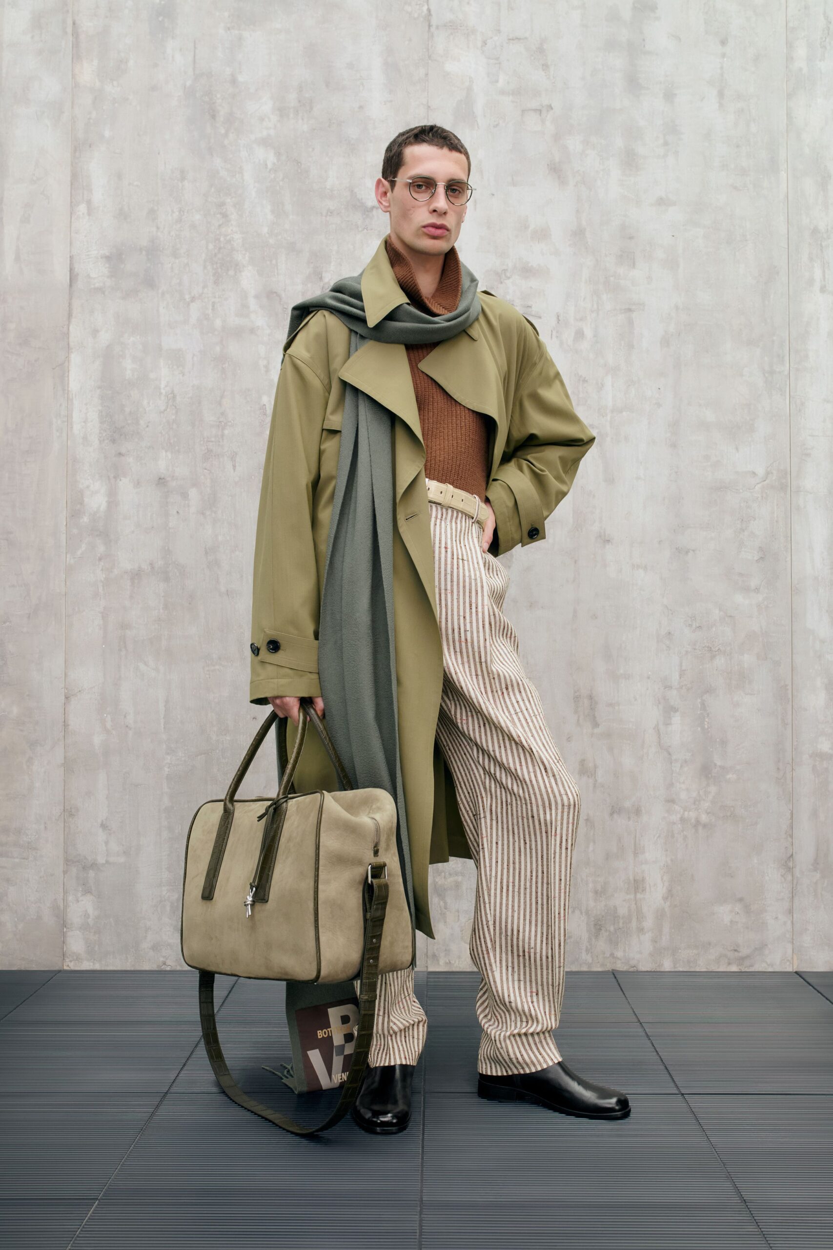 green coat brown sweater striped pants