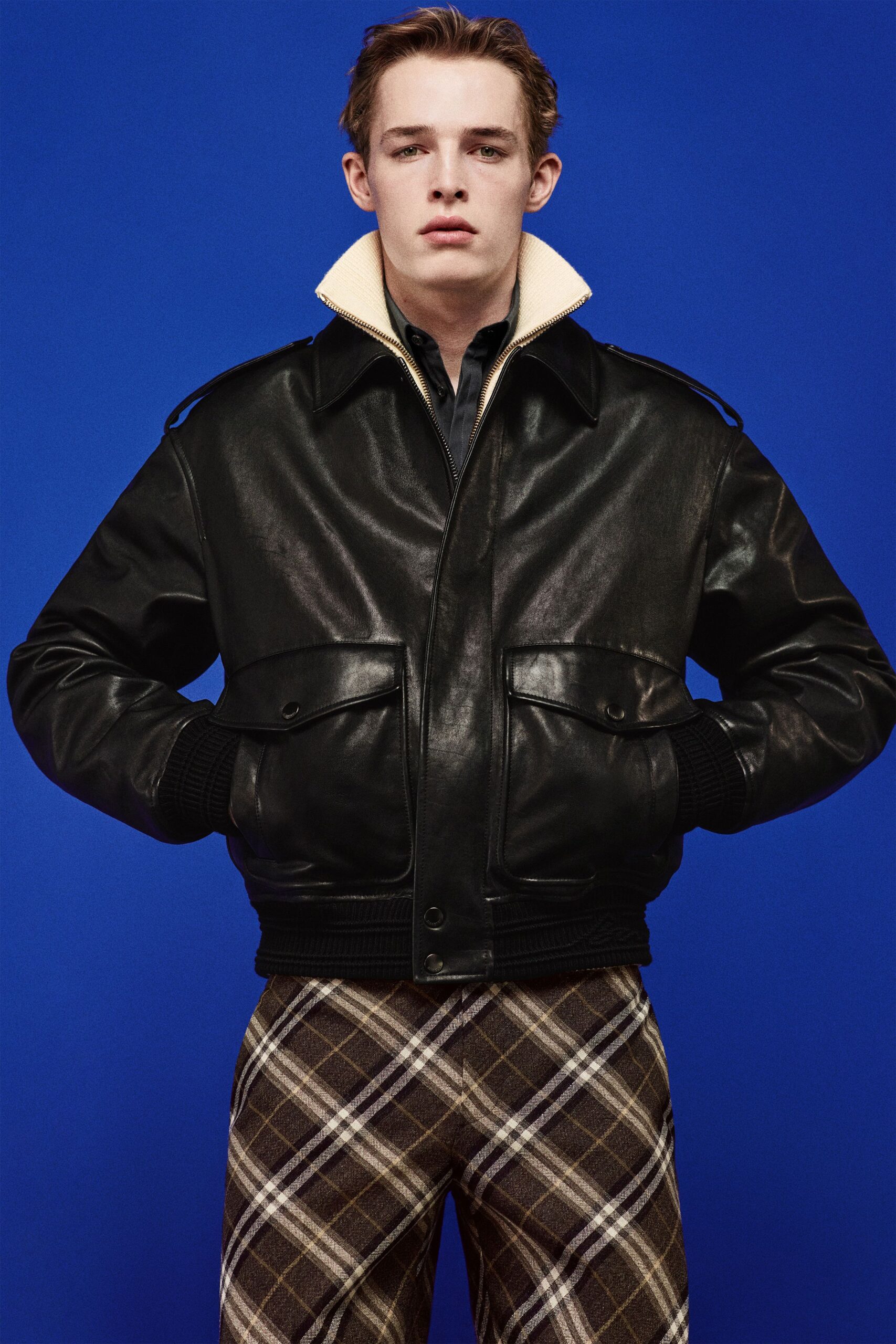 black leather jacket and checked pants
