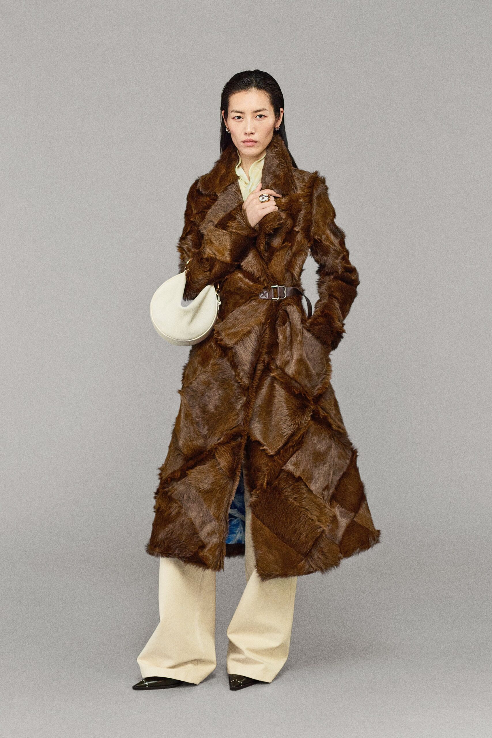 brown faux-fur coat with beige pants