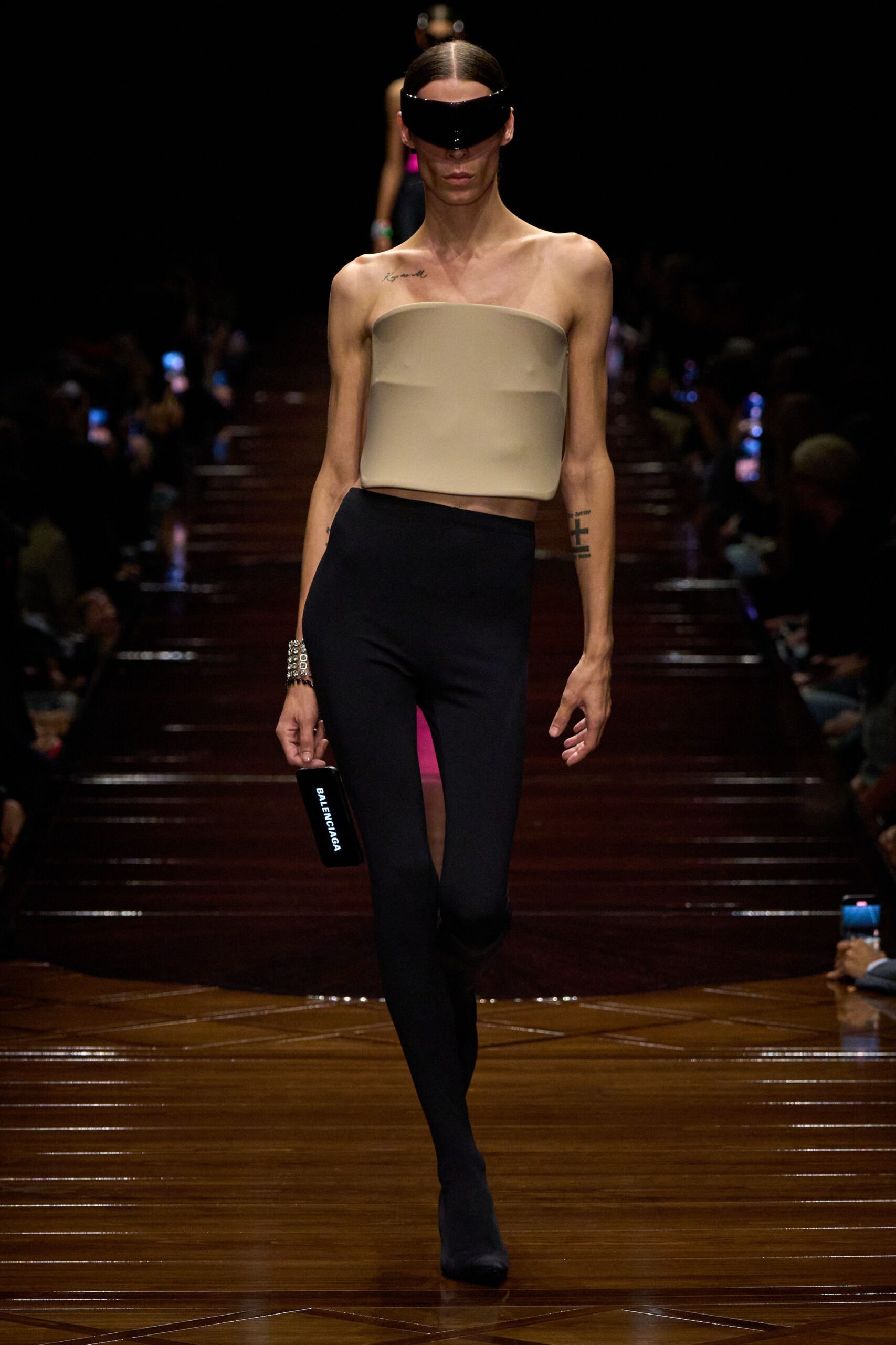 beige fitted top with black leggings