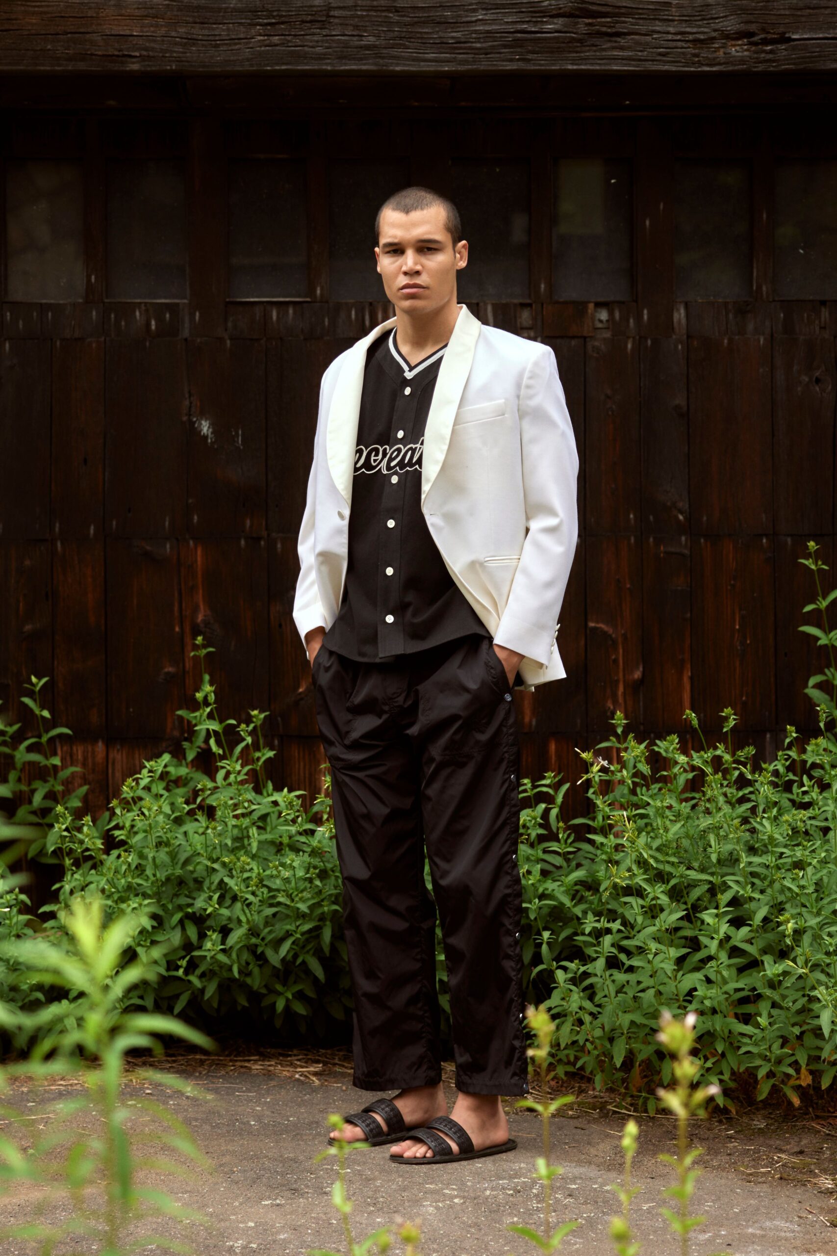 white tailored blazer black shirt black pants black sandals