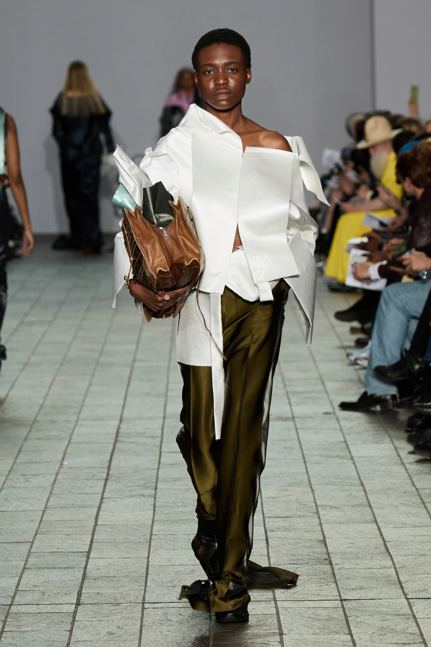 white off-shoulder top with green pants