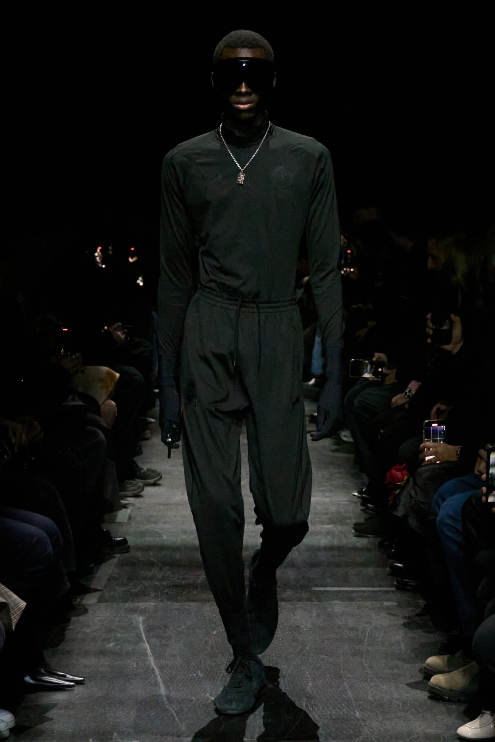 black fitted jumpsuit with sunglasses