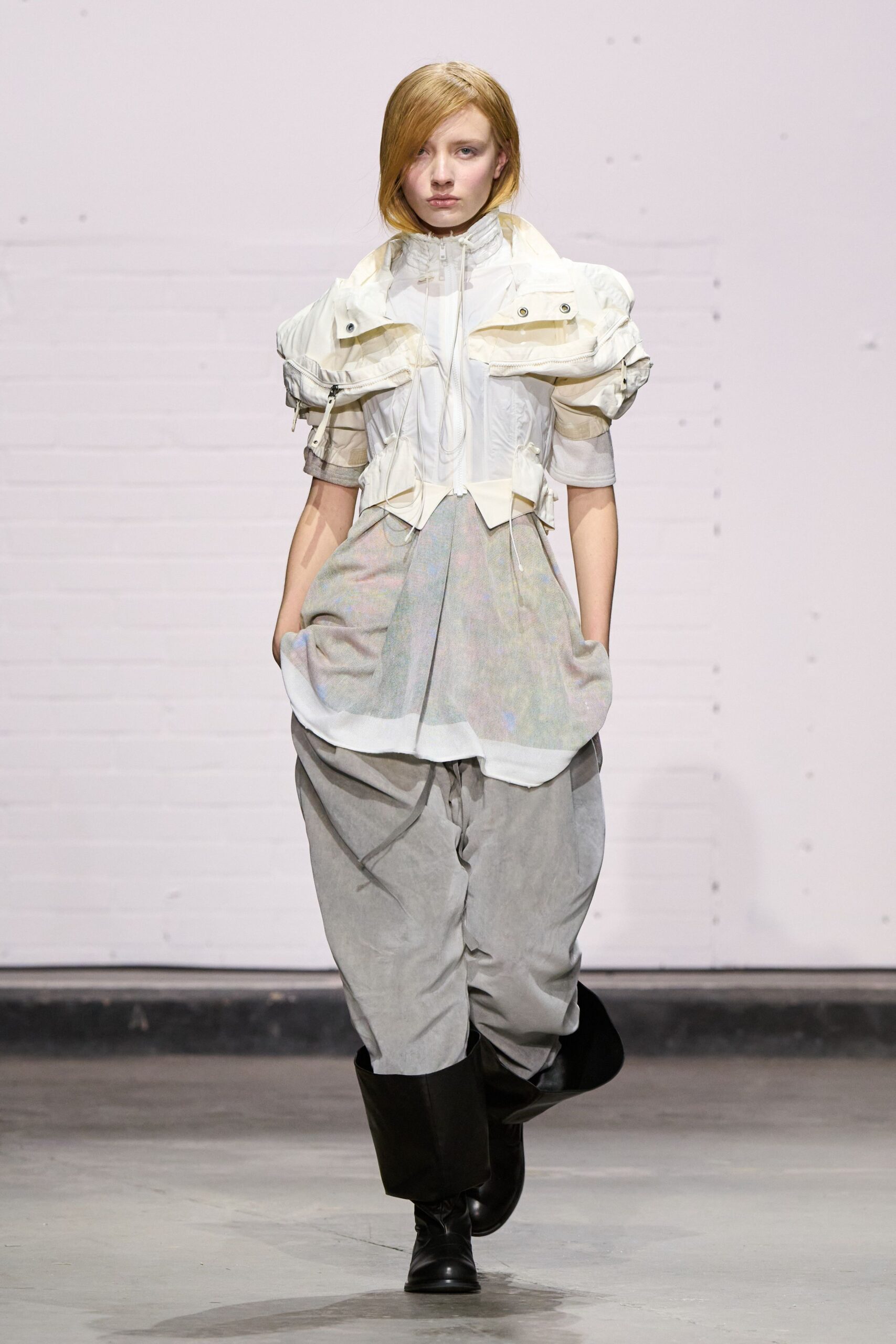 white relaxed top gray pants black boots