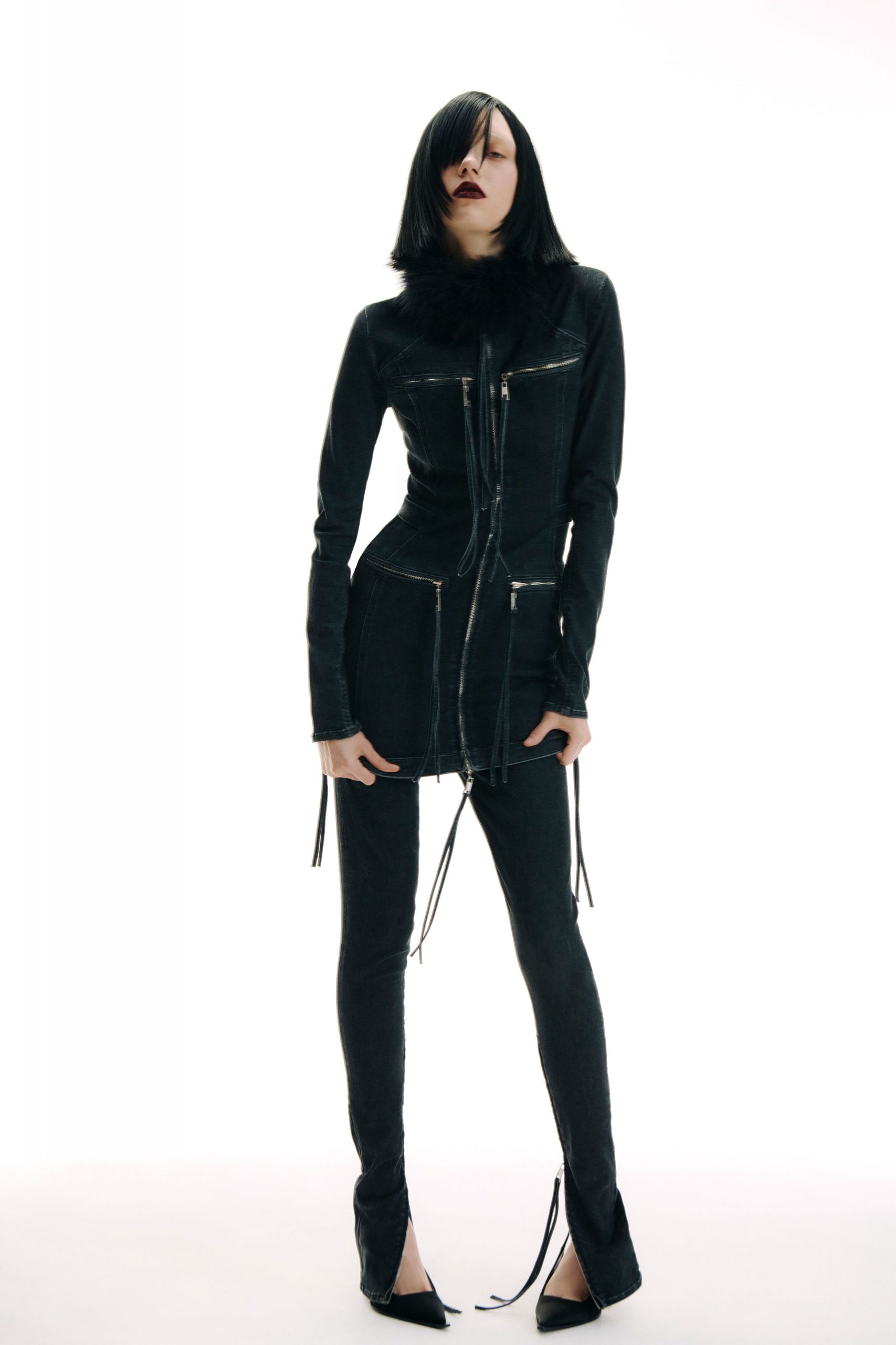 black fitted denim jumpsuit with pointed shoes