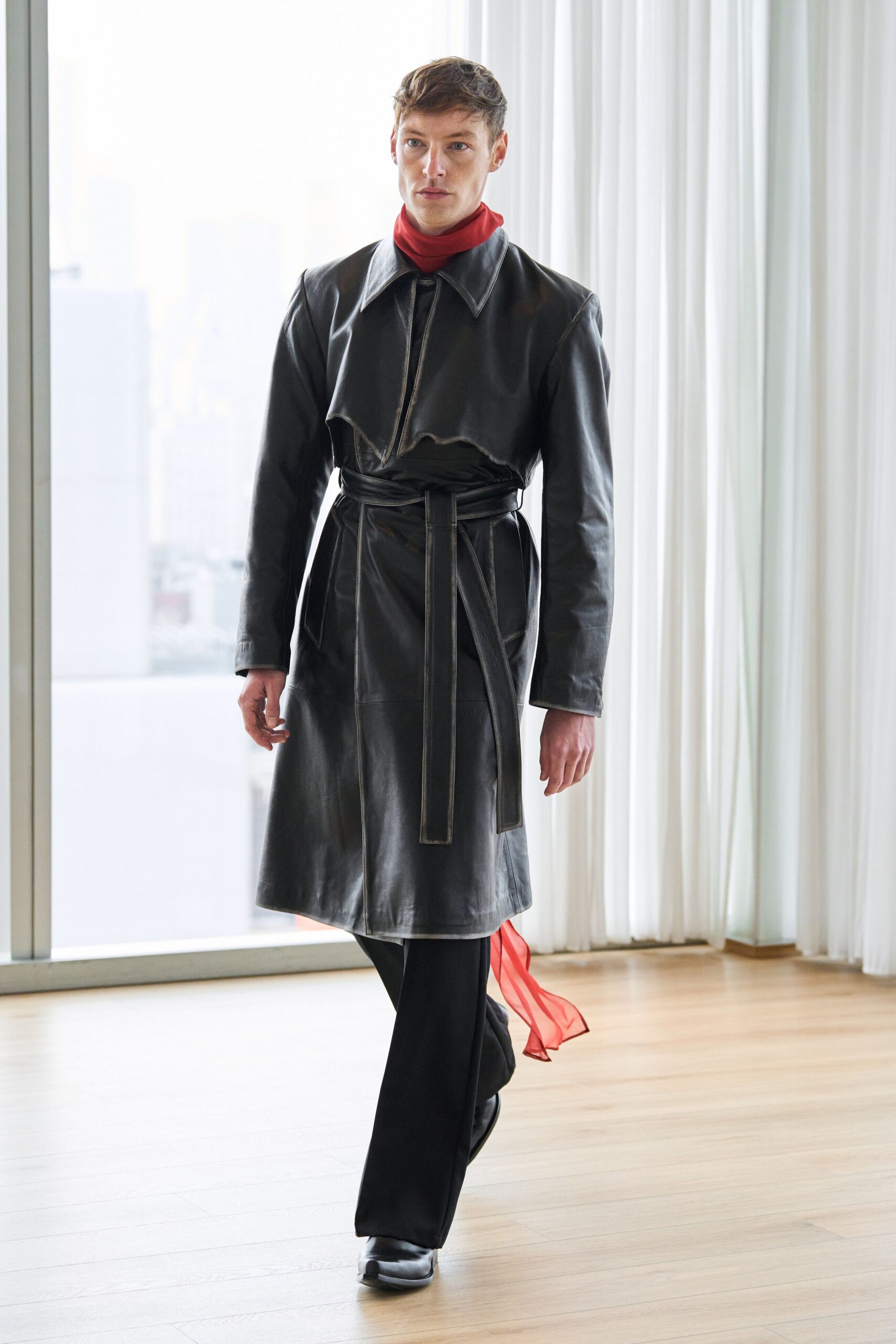 black leather coat with red scarf