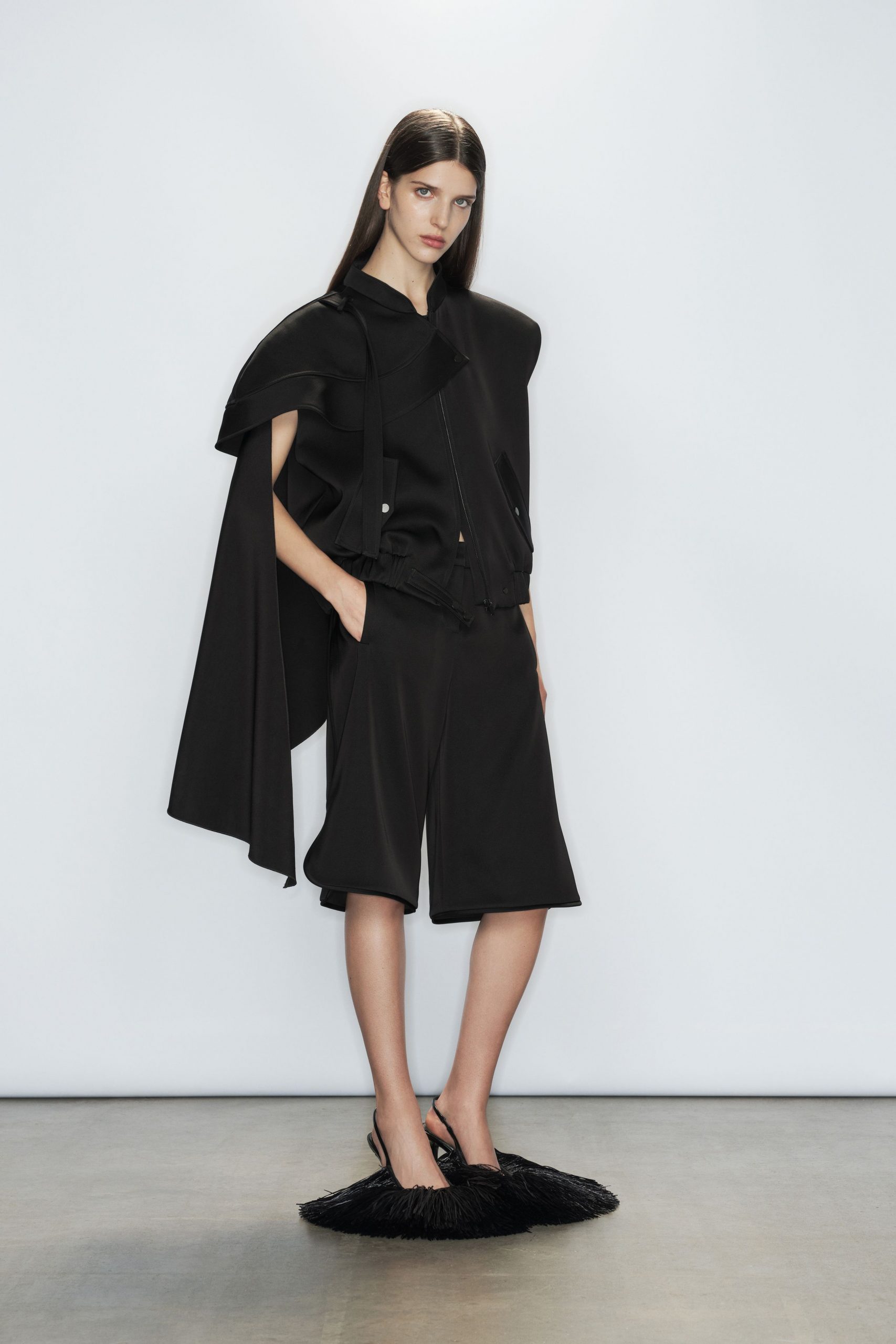 black cape and shorts ensemble