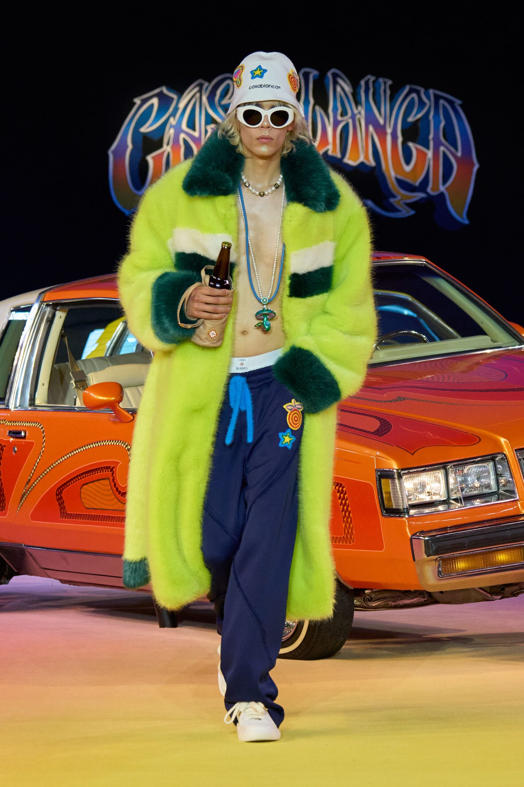 green faux-fur coat with blue pants