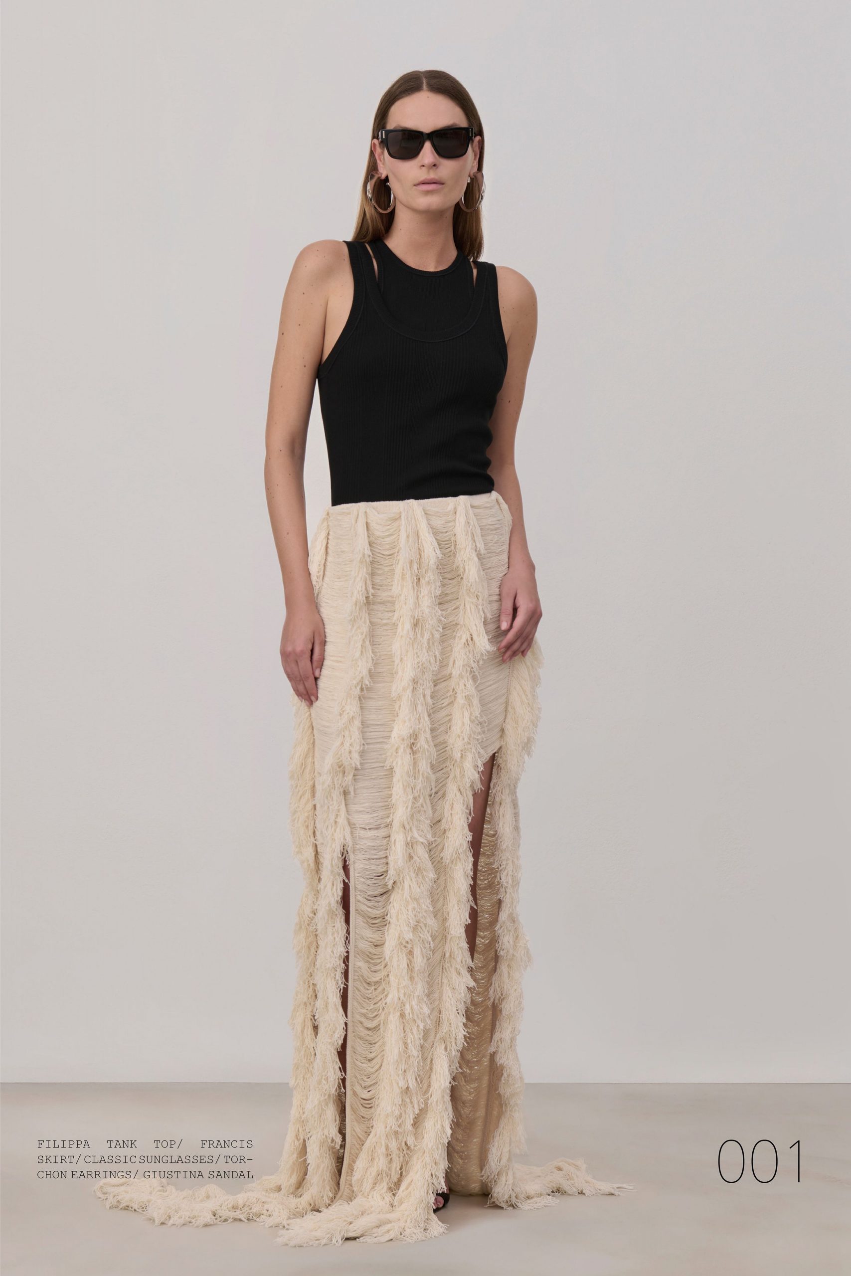 black tank top and beige fringed skirt