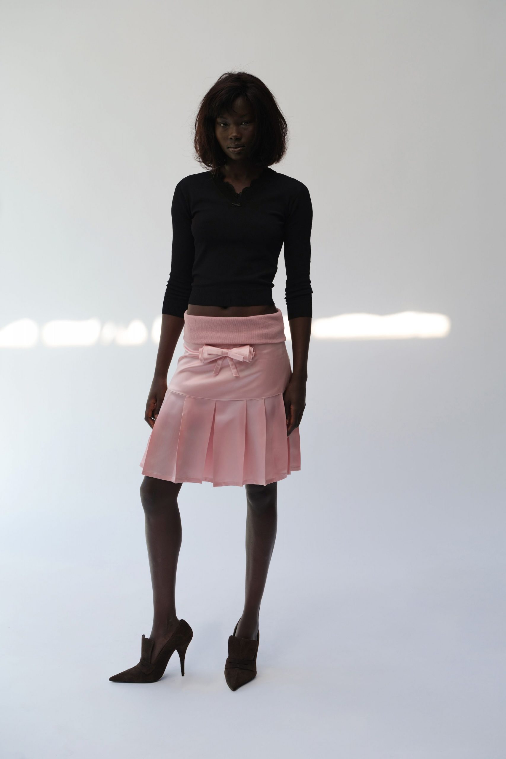 black fitted top pink pleated skirt