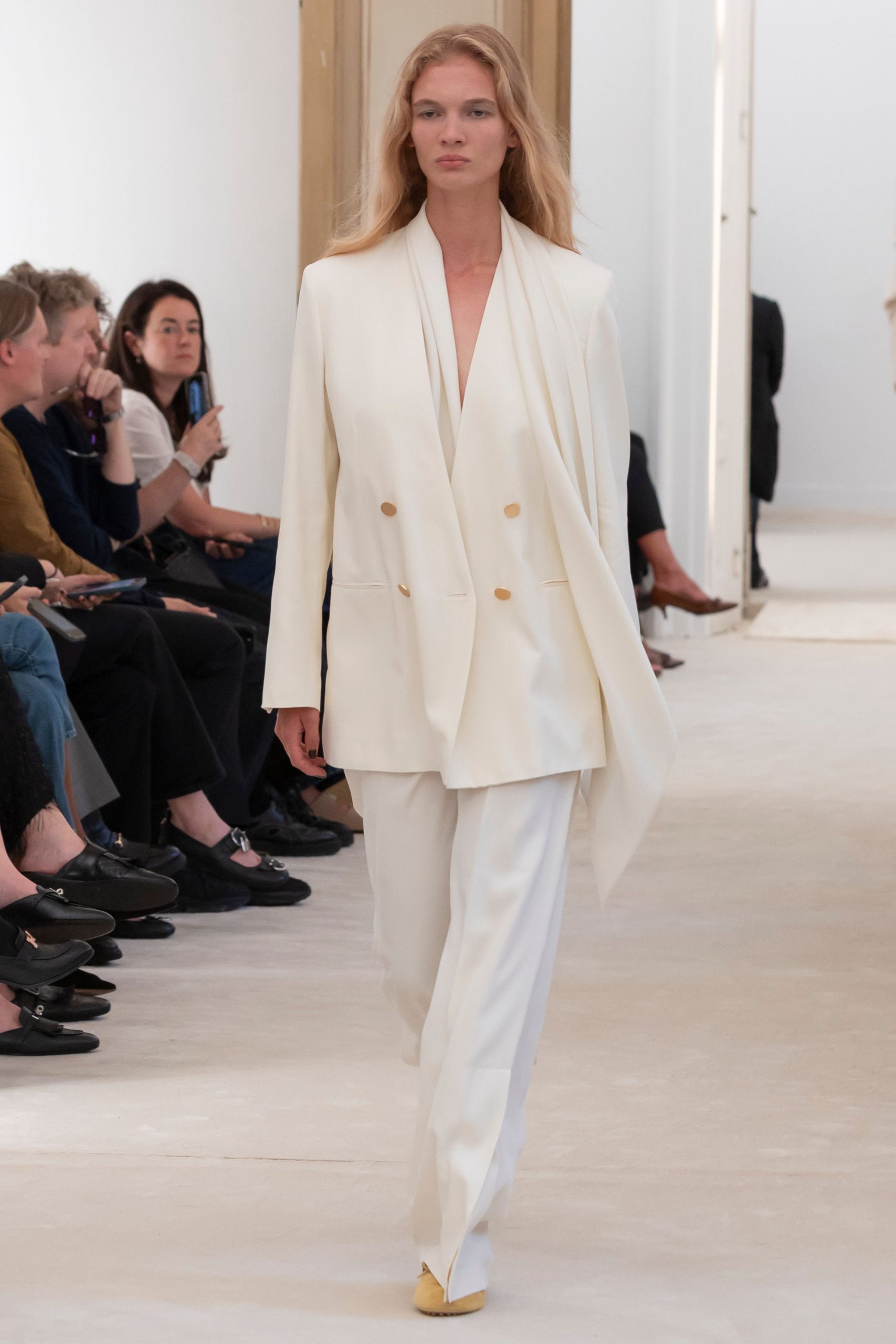 white tailored suit with beige shoes