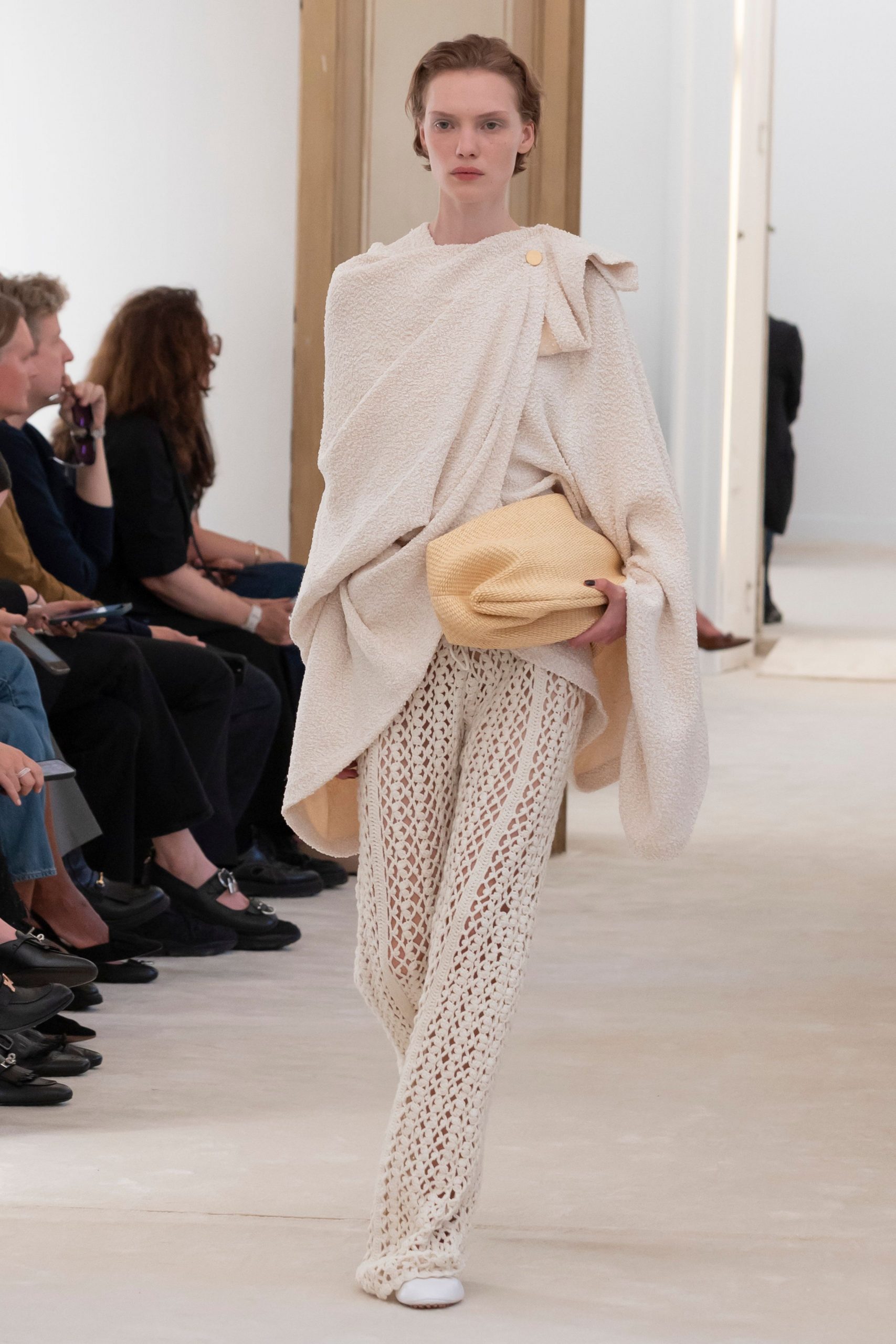 white oversized poncho with beige crochet pants