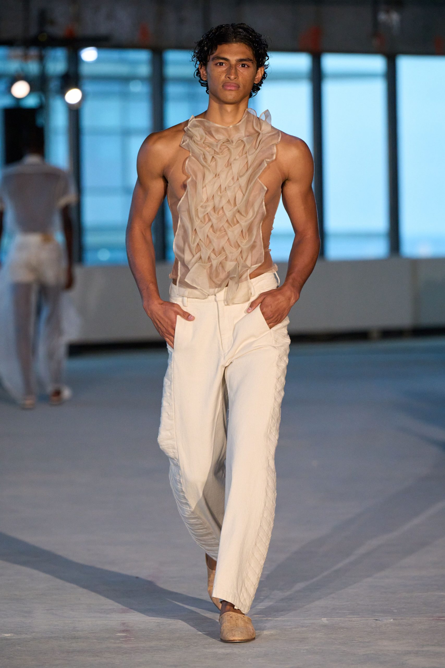 beige ruffled top with white pants