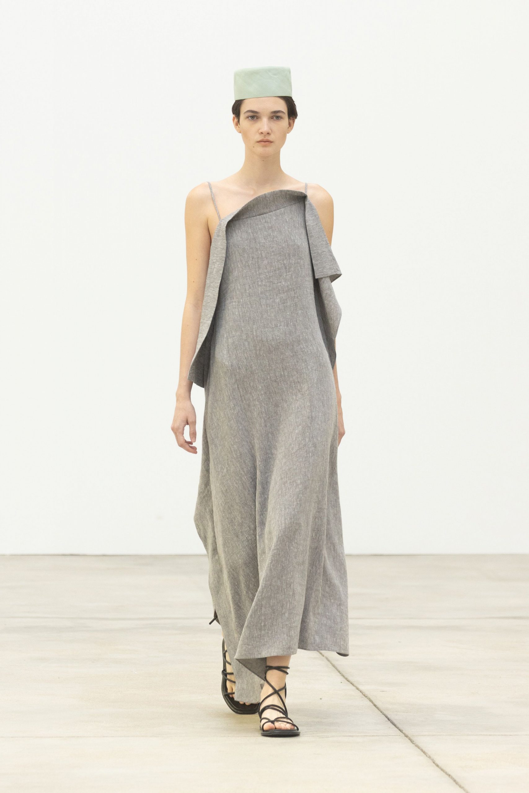 gray draped maxi dress with green hat