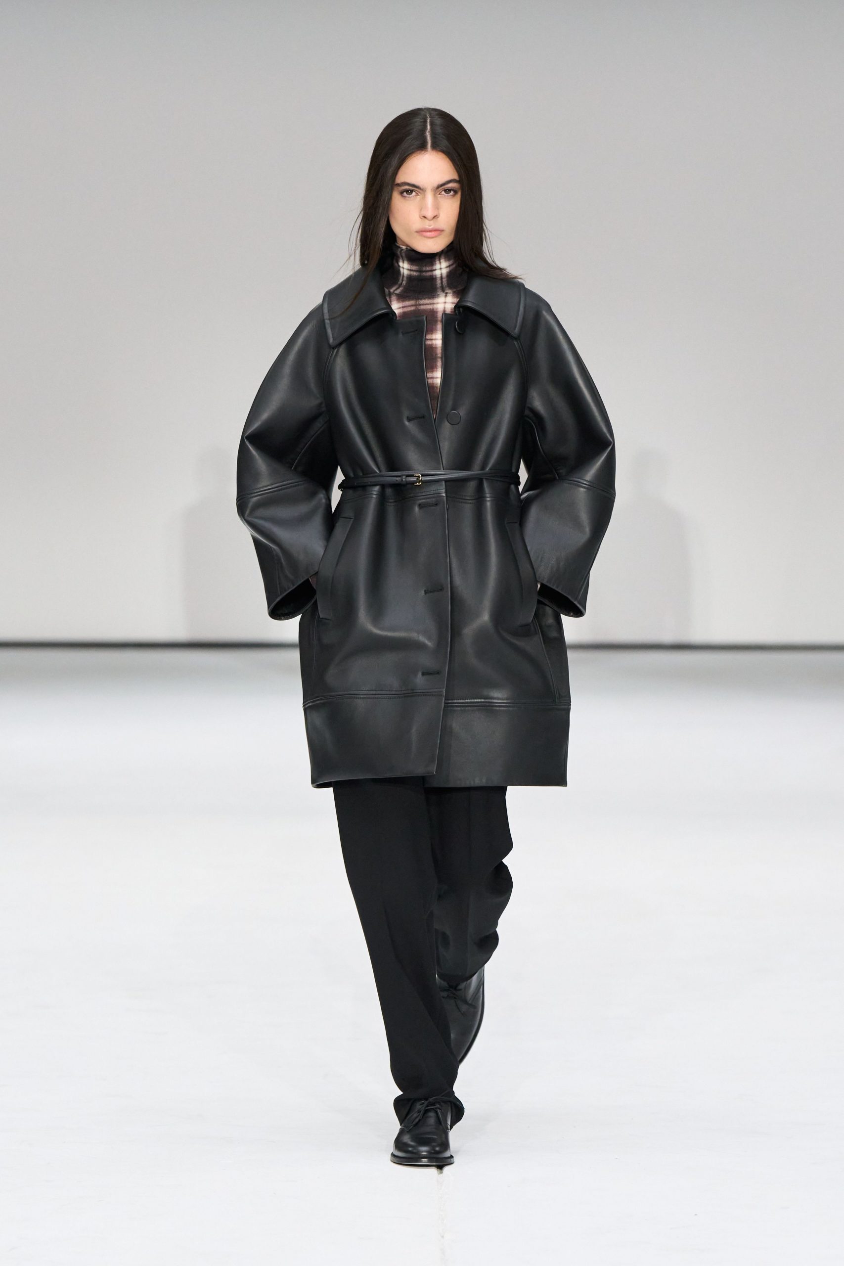 black leather long-sleeve collared relaxed belted coat