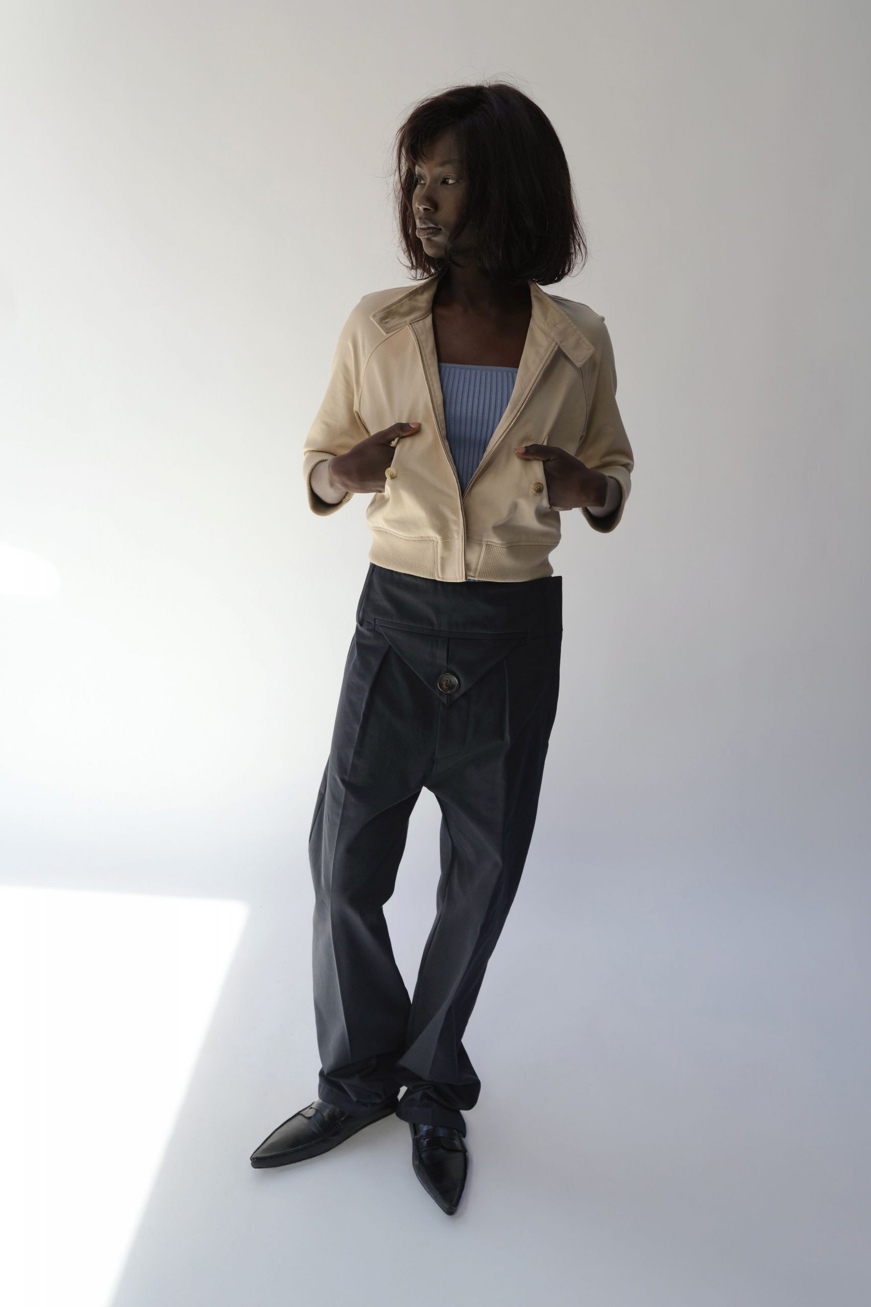 beige jacket blue top black pants