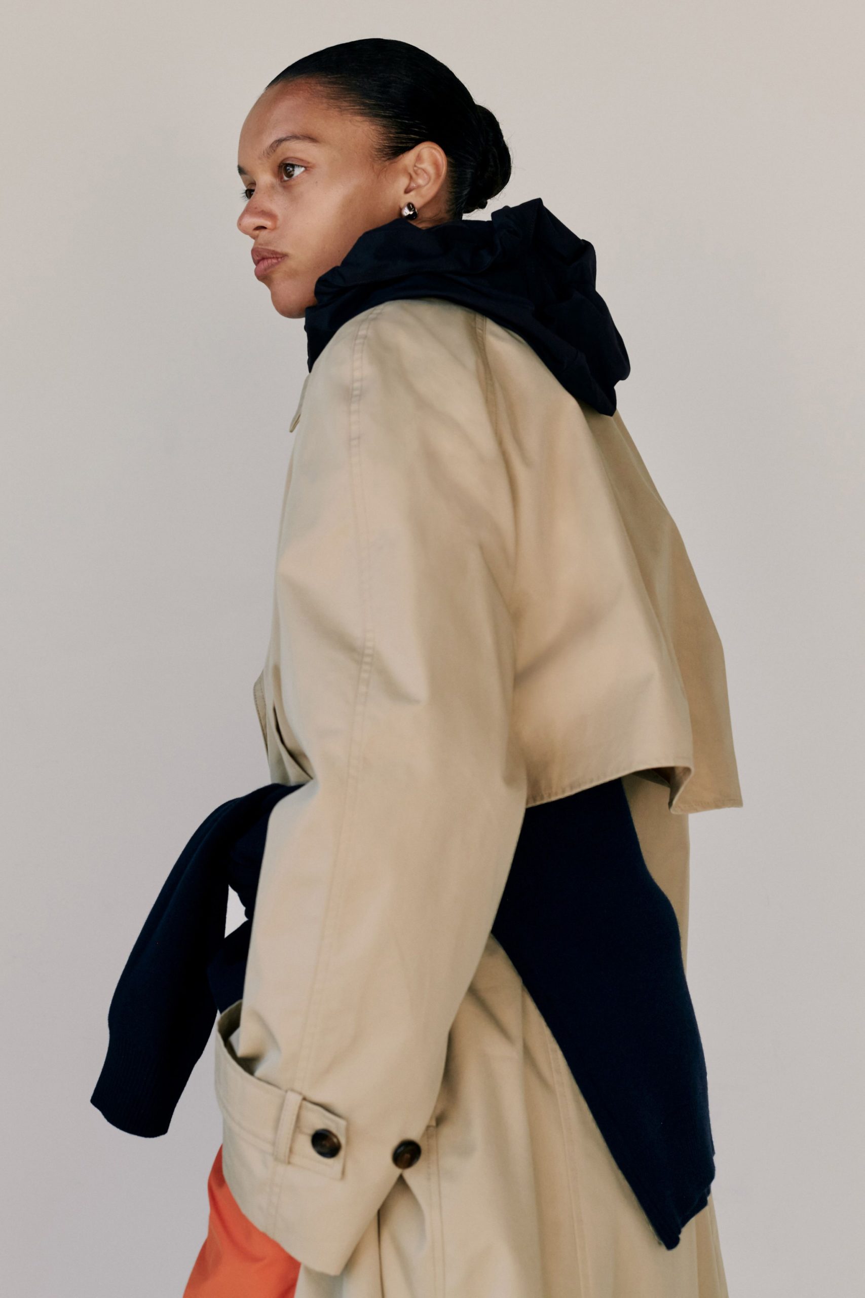 beige coat with navy hoodie