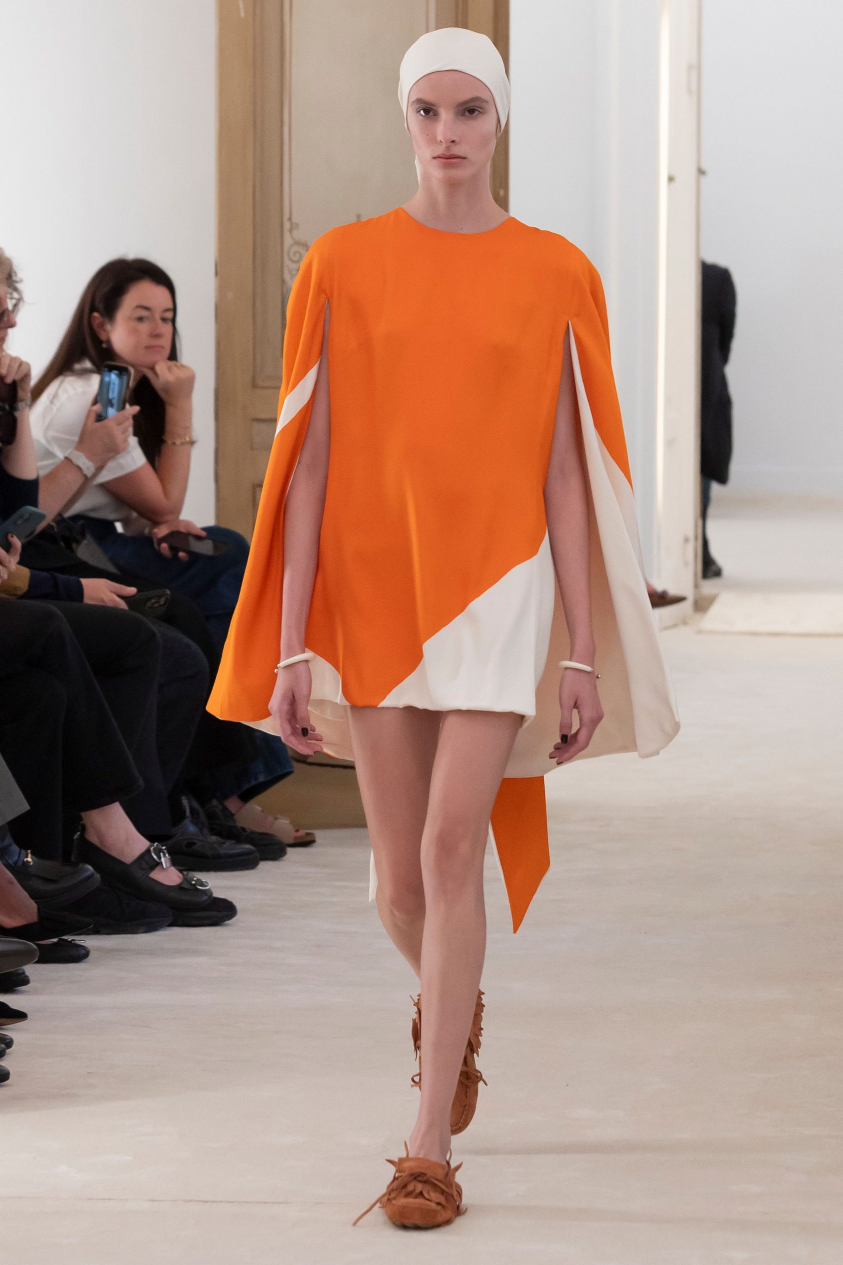 orange and white asymmetric cape with shorts