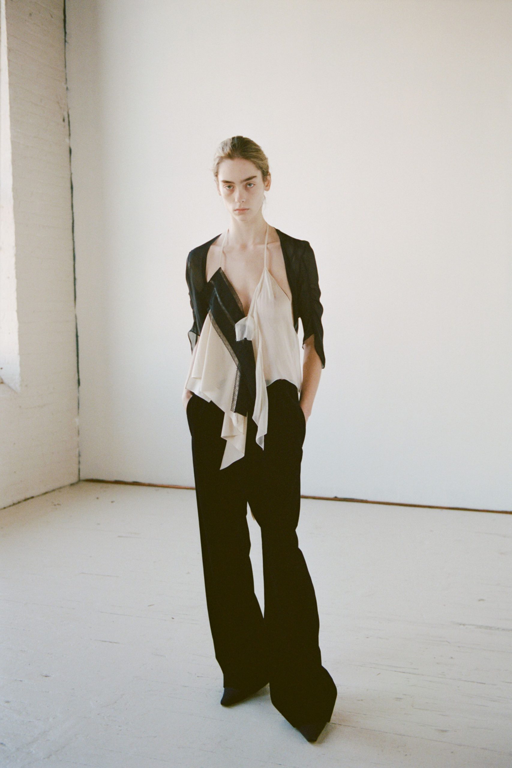 white silk ruffled top and black pants