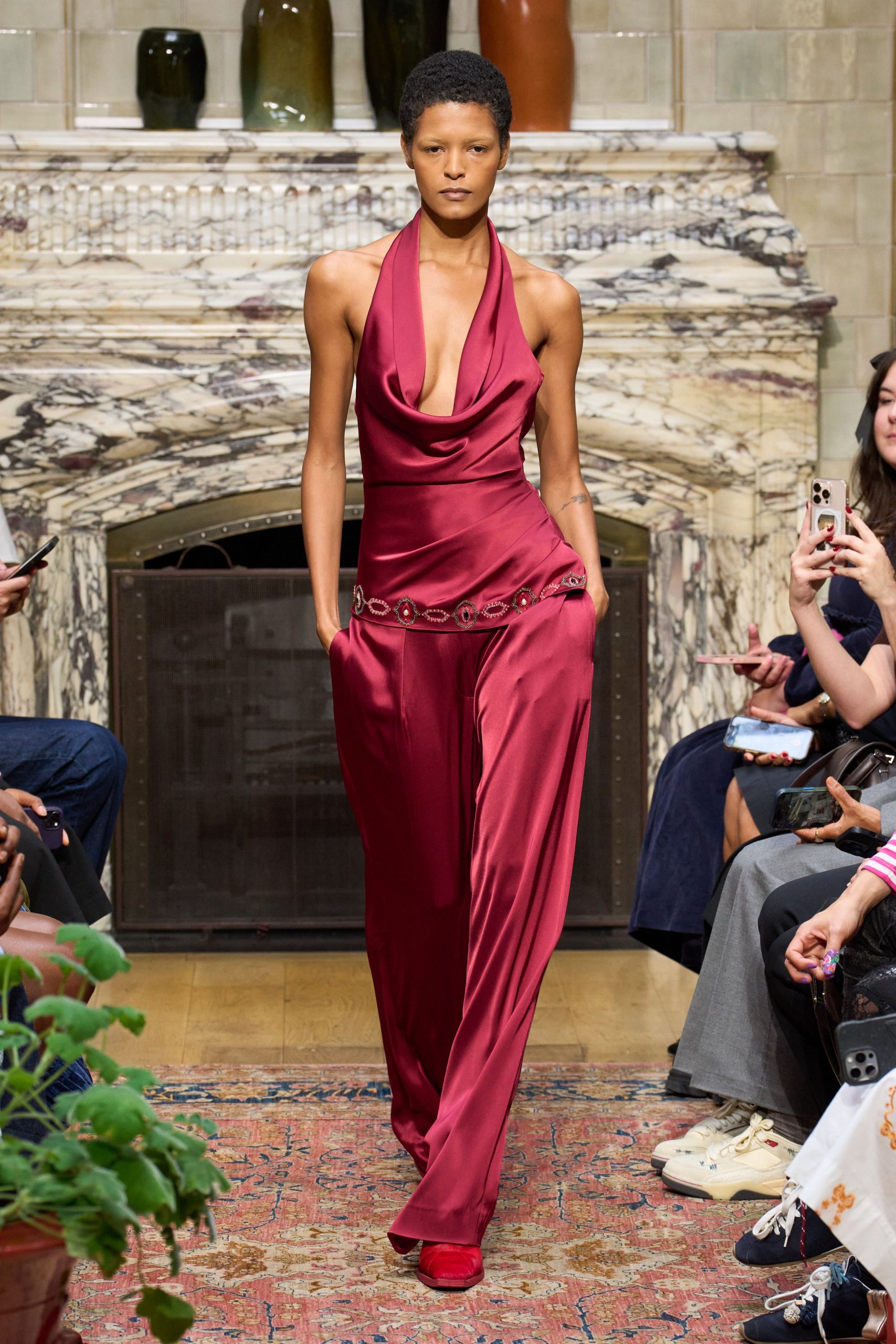 red silk sleeveless v-neck fitted draped belted jumpsuit