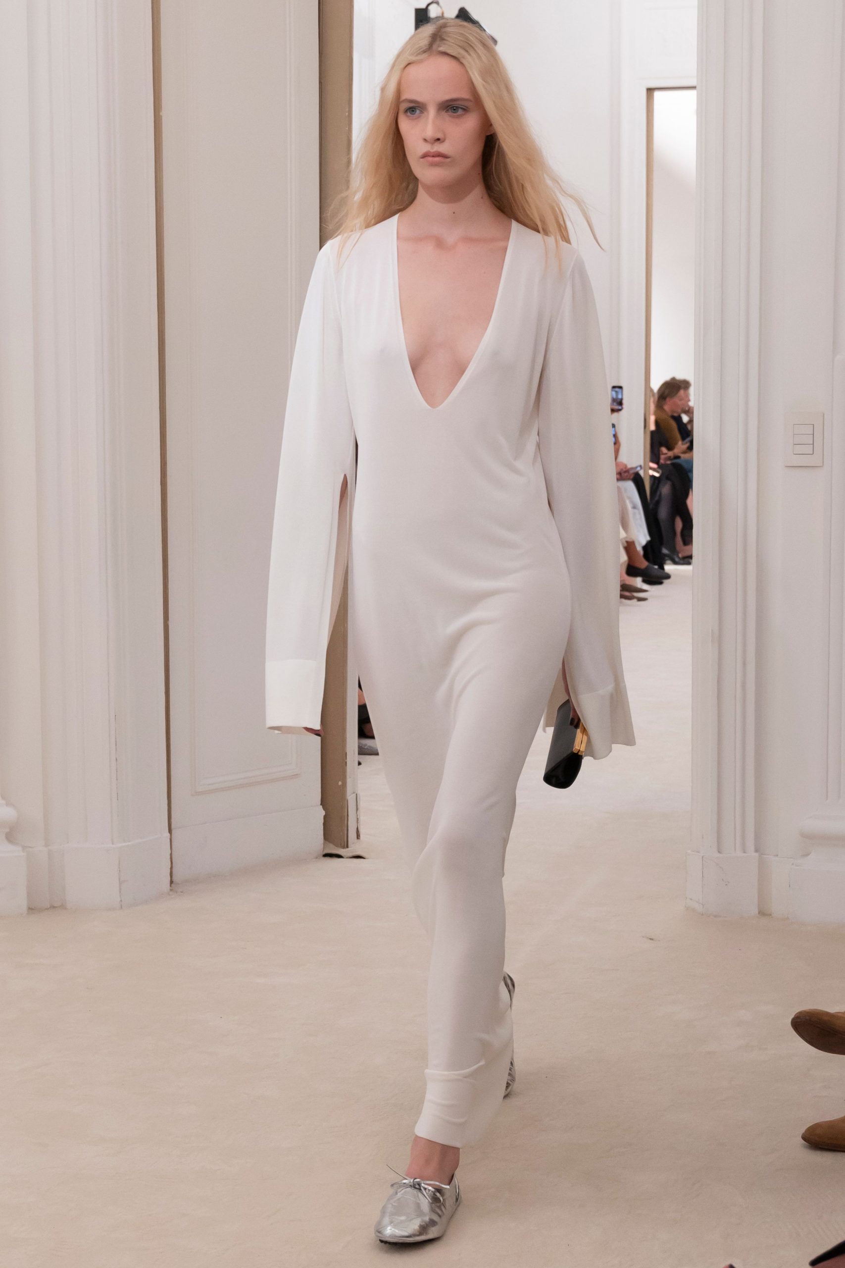 white fitted jumpsuit with silver shoes