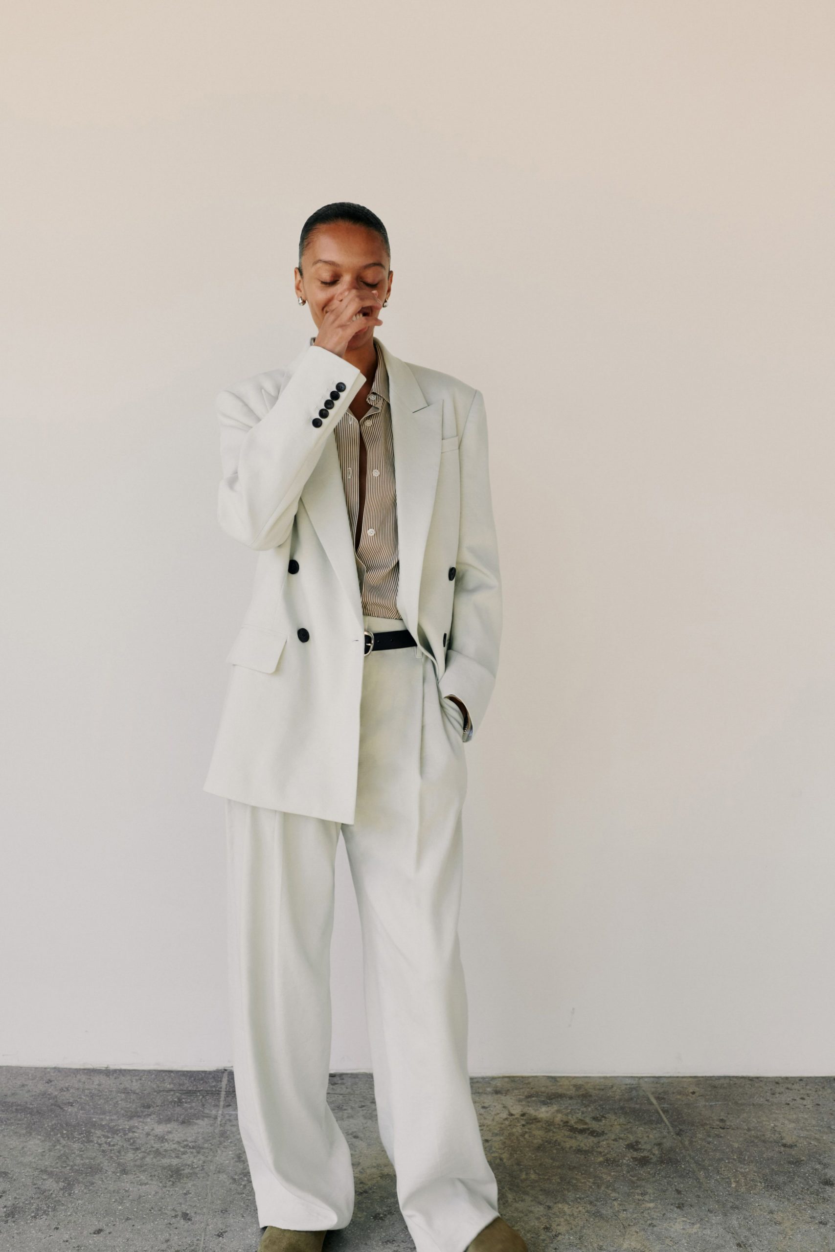 white relaxed suit with beige shirt