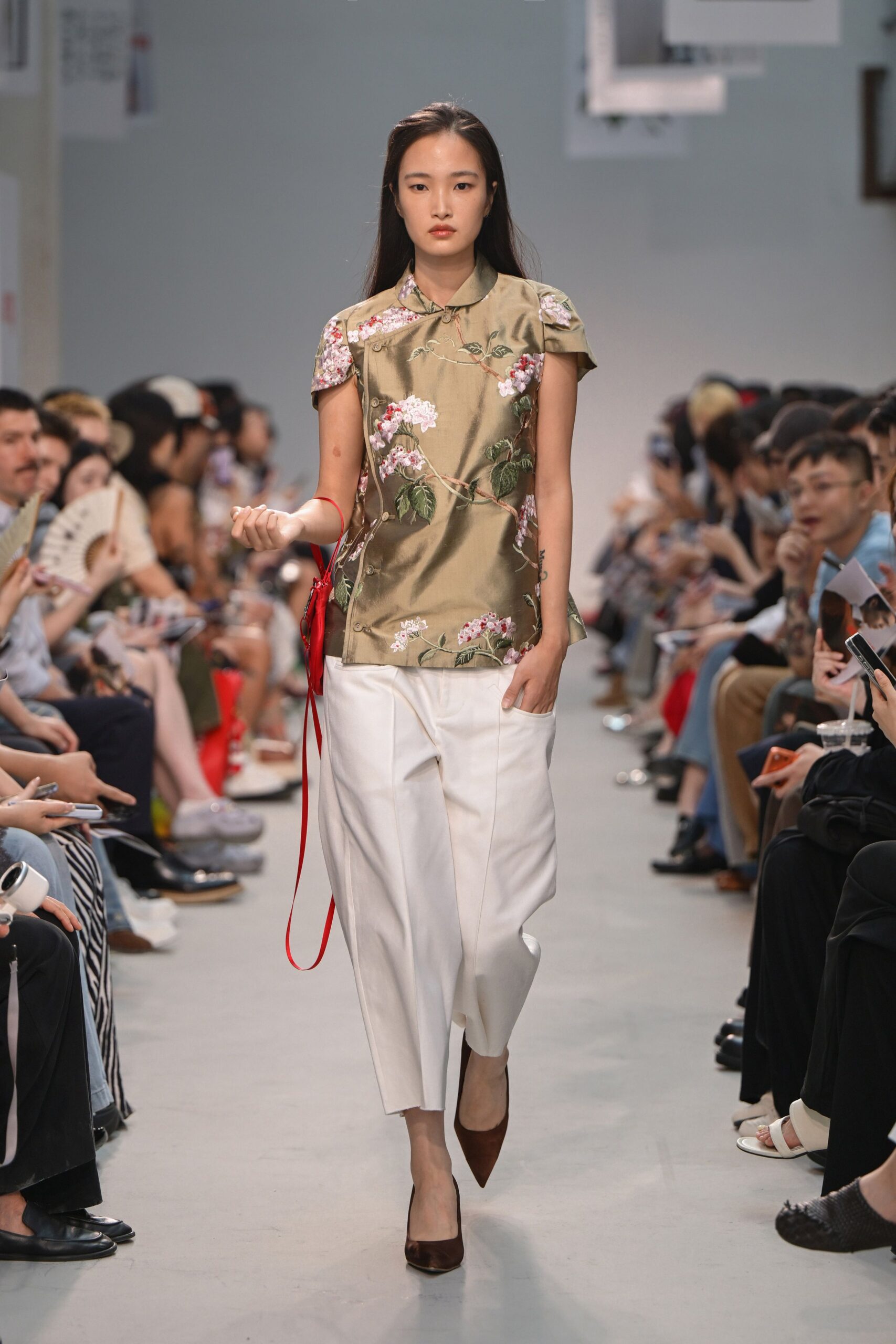 green embroidered silk top with white pants