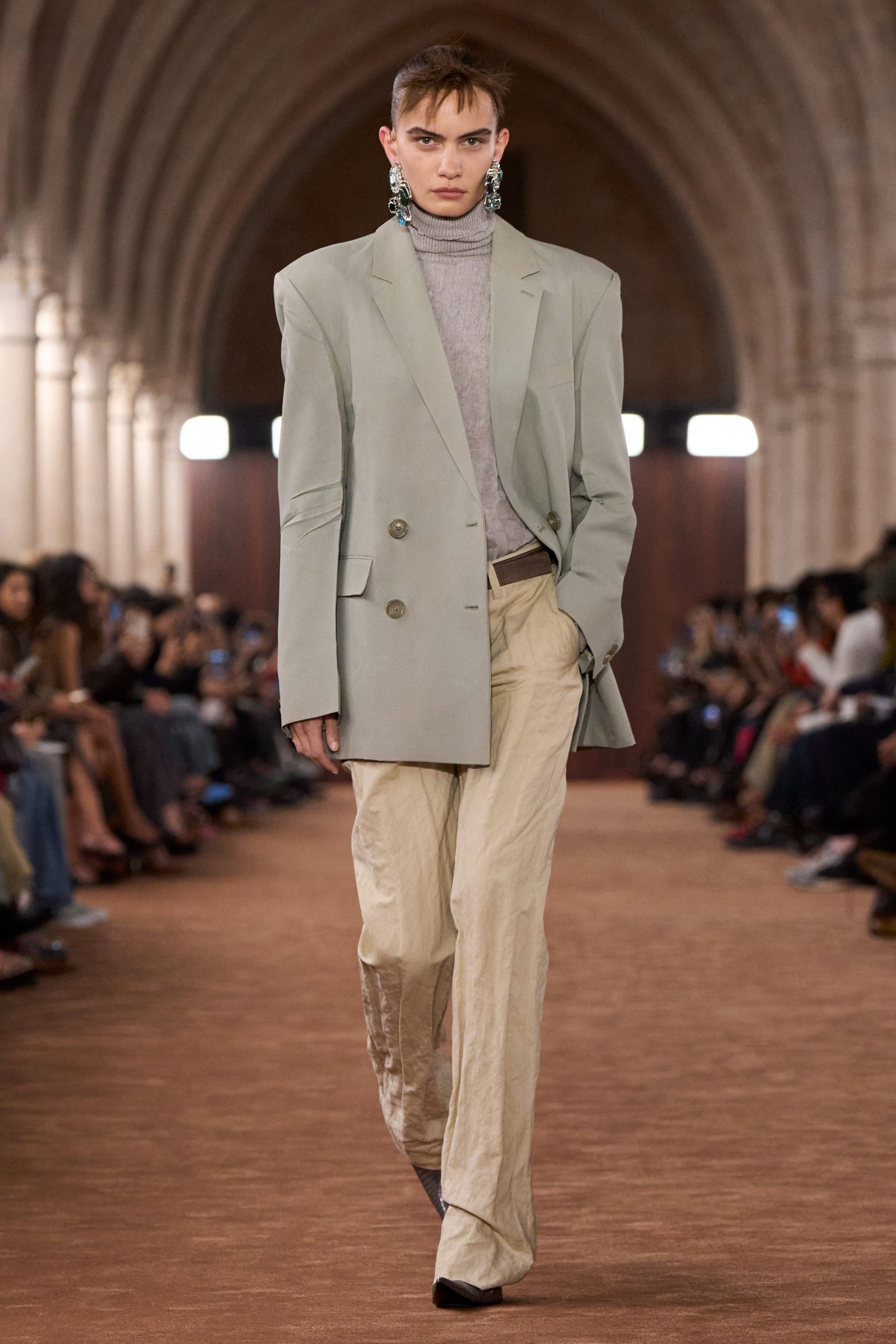 green blazer gray turtleneck beige pants