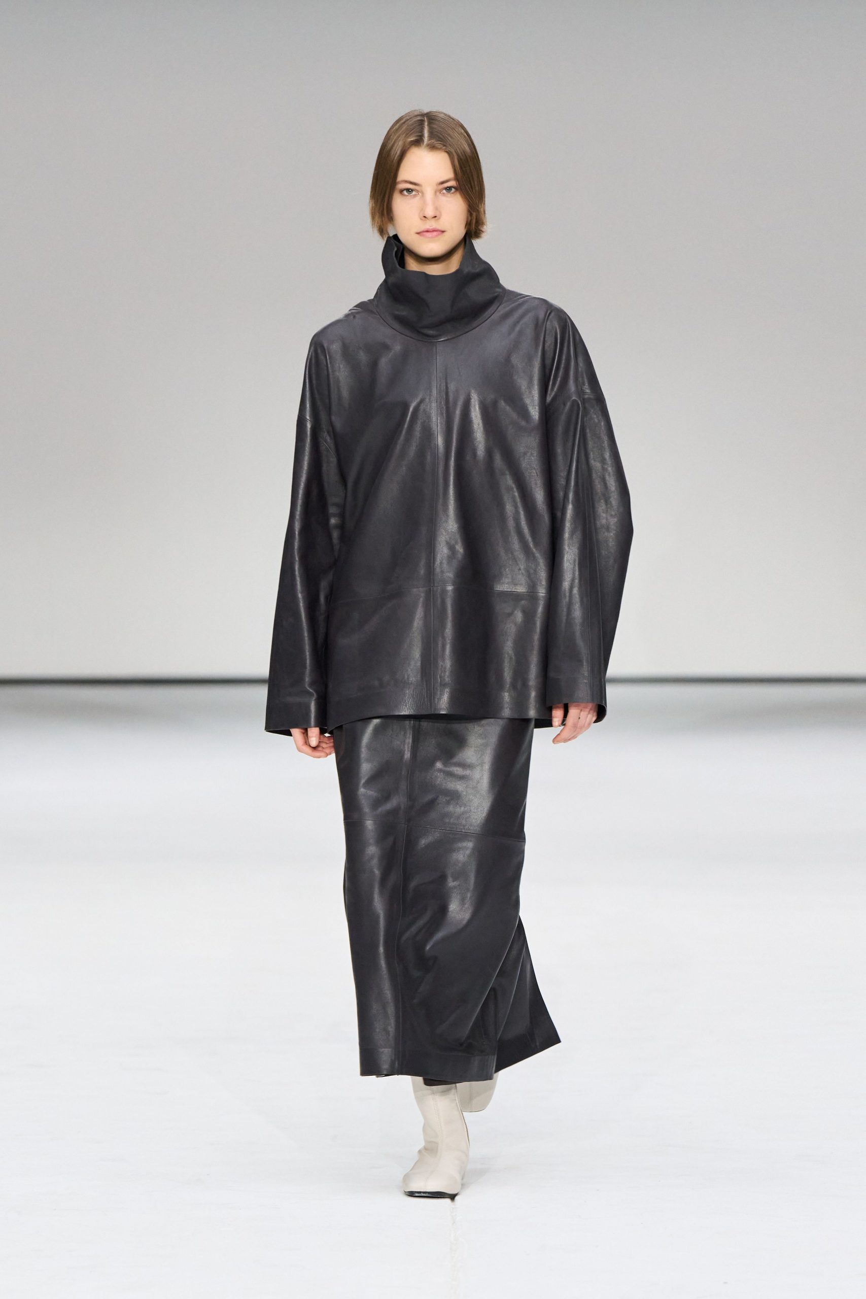 black leather top and skirt with white boots