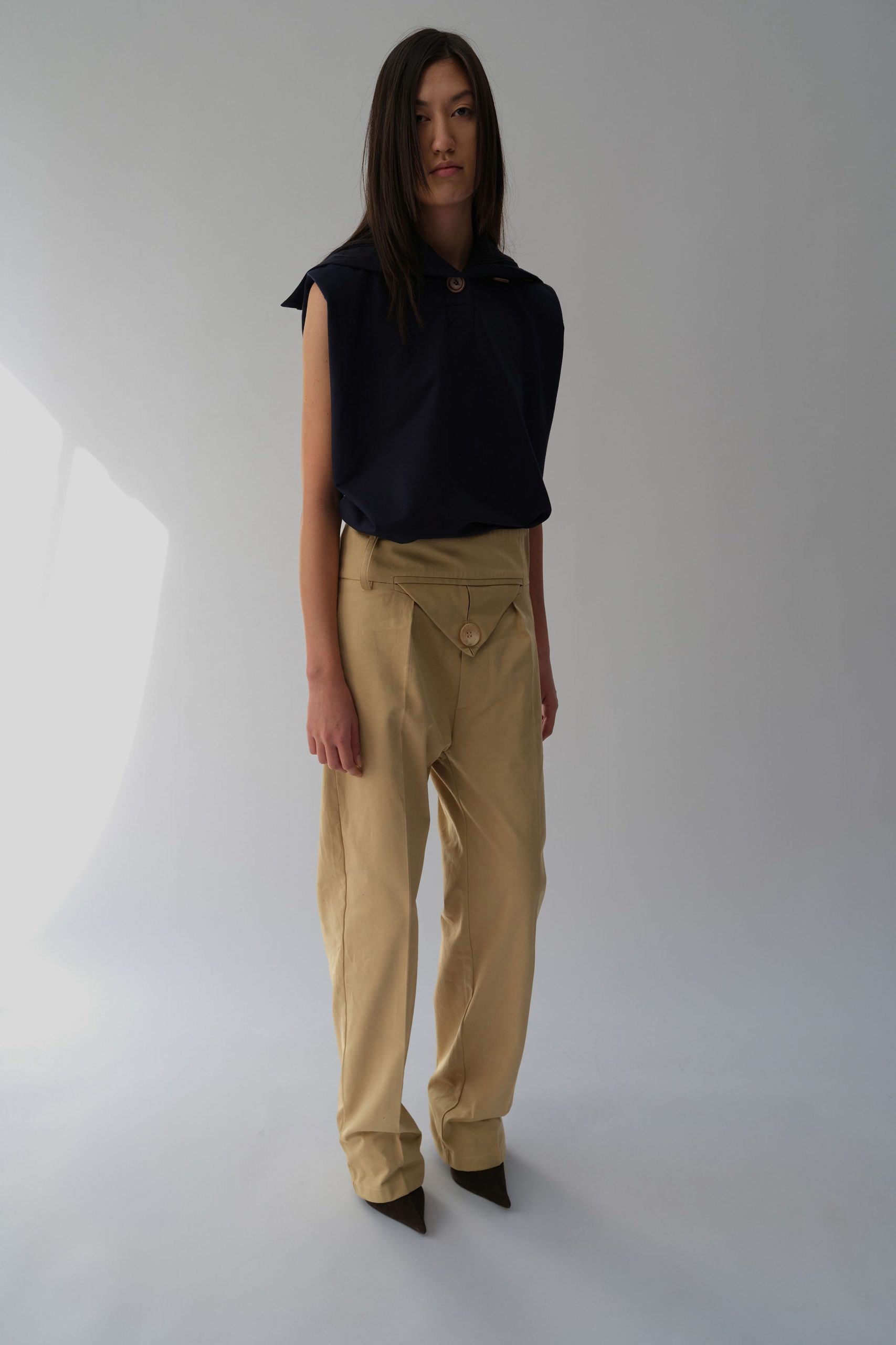 navy relaxed top beige pants black heels