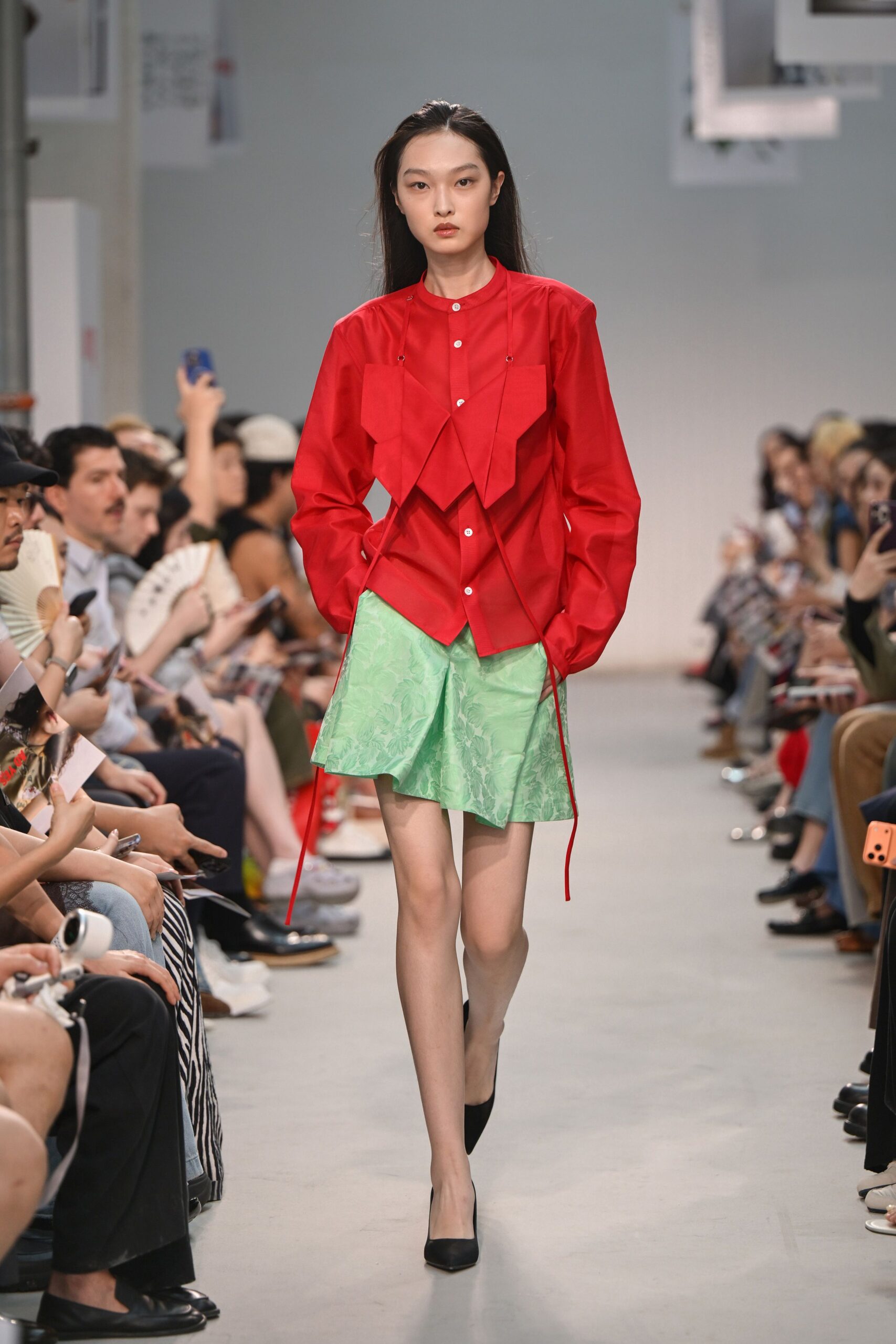 red shirt green skirt black heels