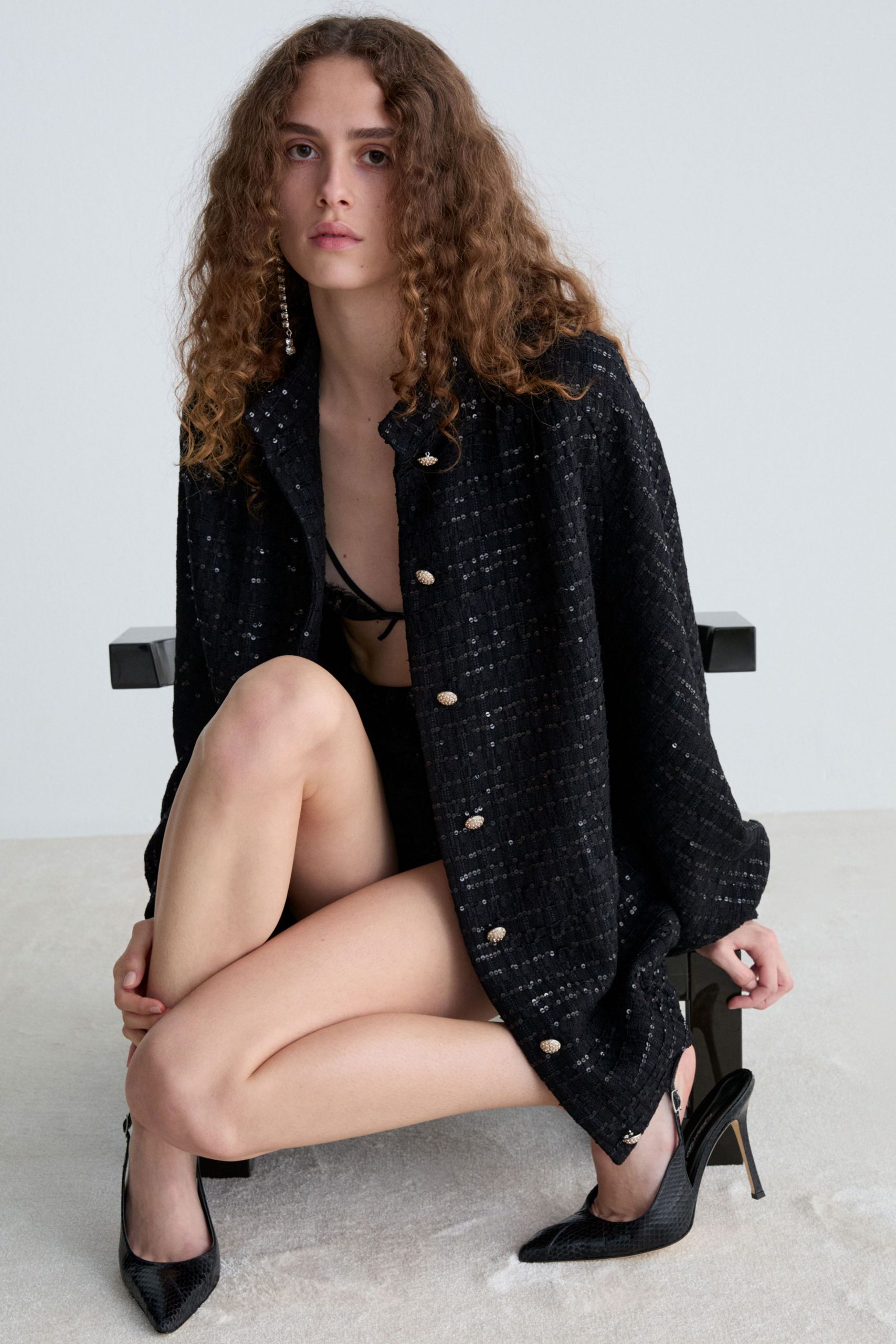 black oversized coat and fitted top