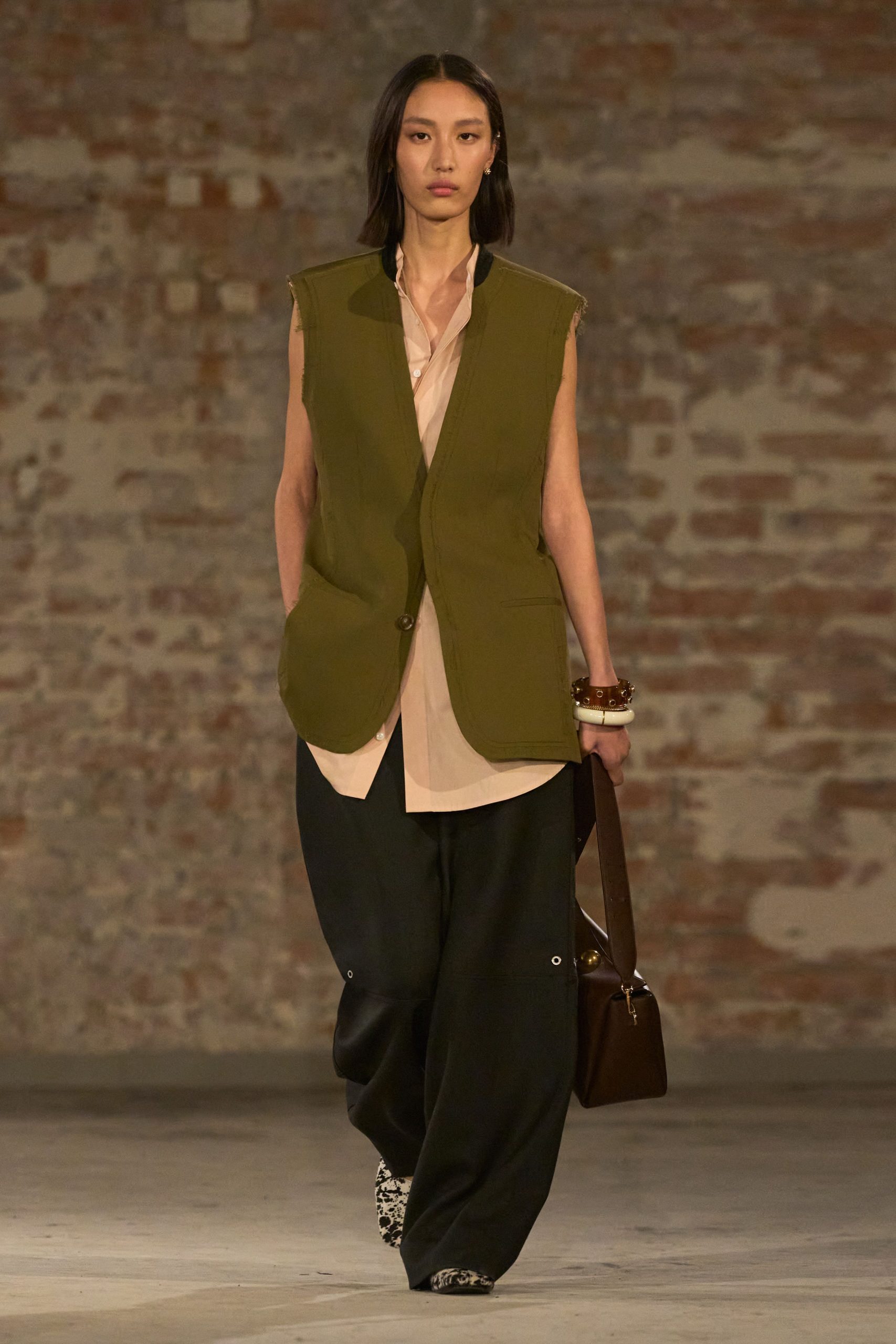 green vest beige shirt black pants