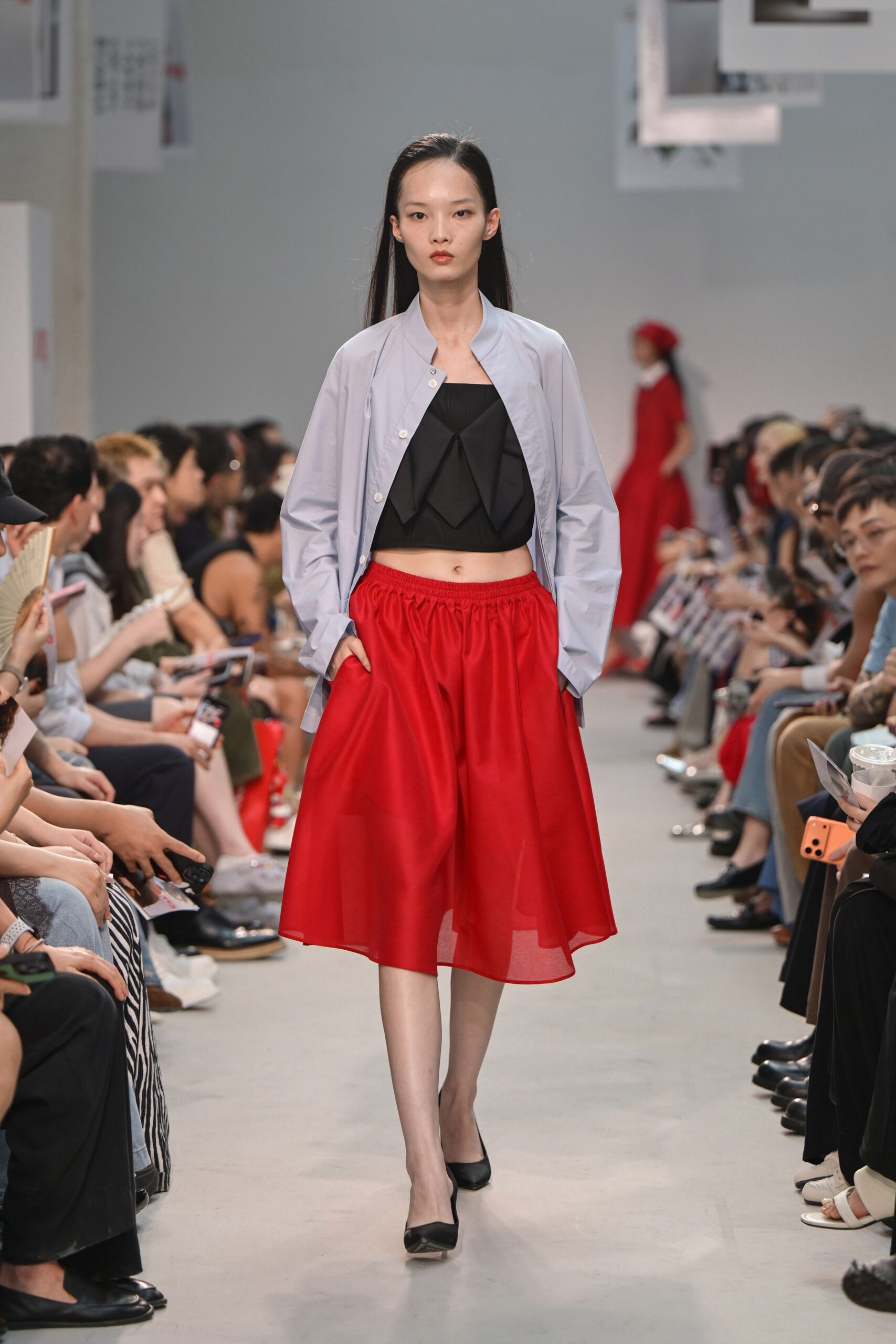 light blue shirt black crop-top red skirt