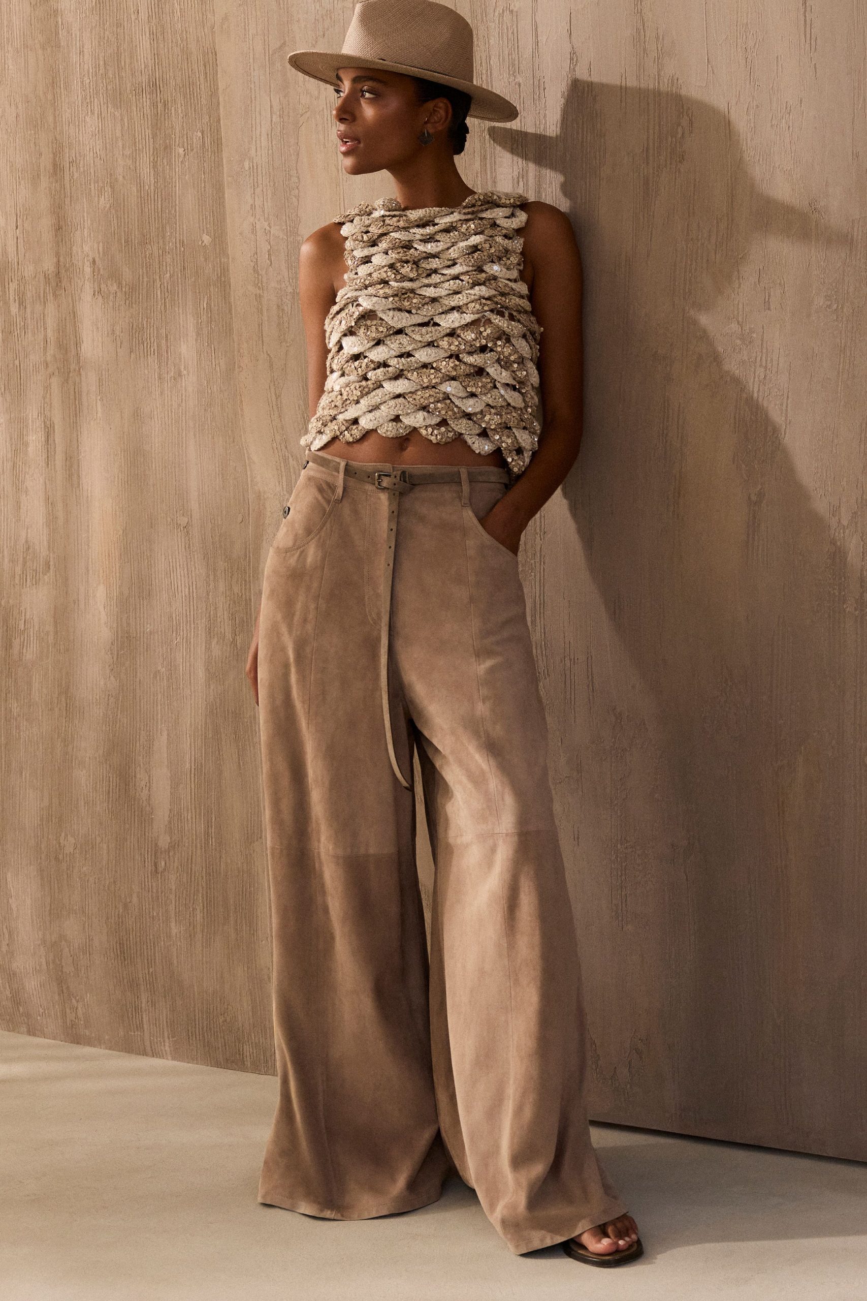 beige ruffled top with tan pants