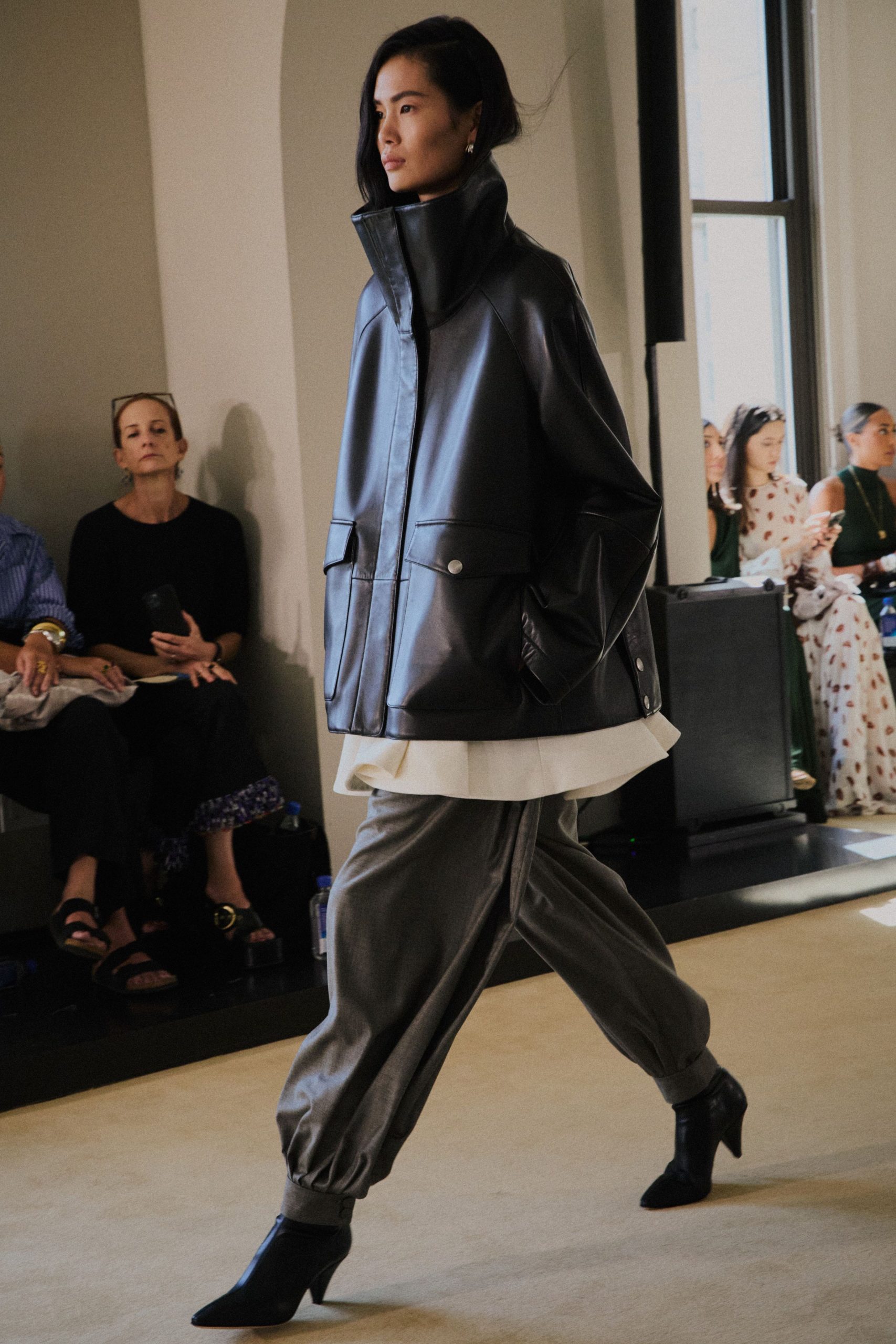 black leather jacket with gray pants