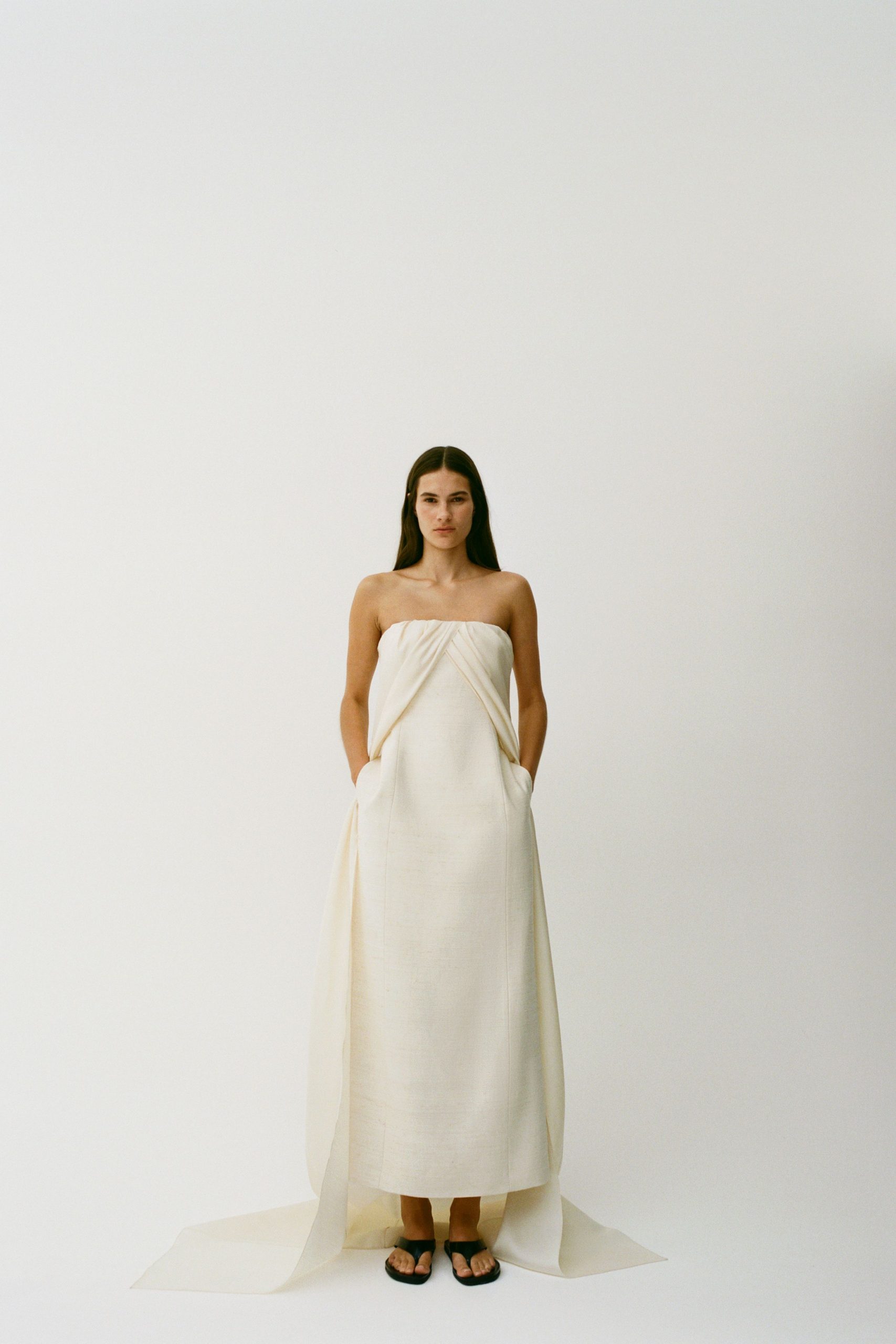 white silk strapless fitted draped pockets maxi gown