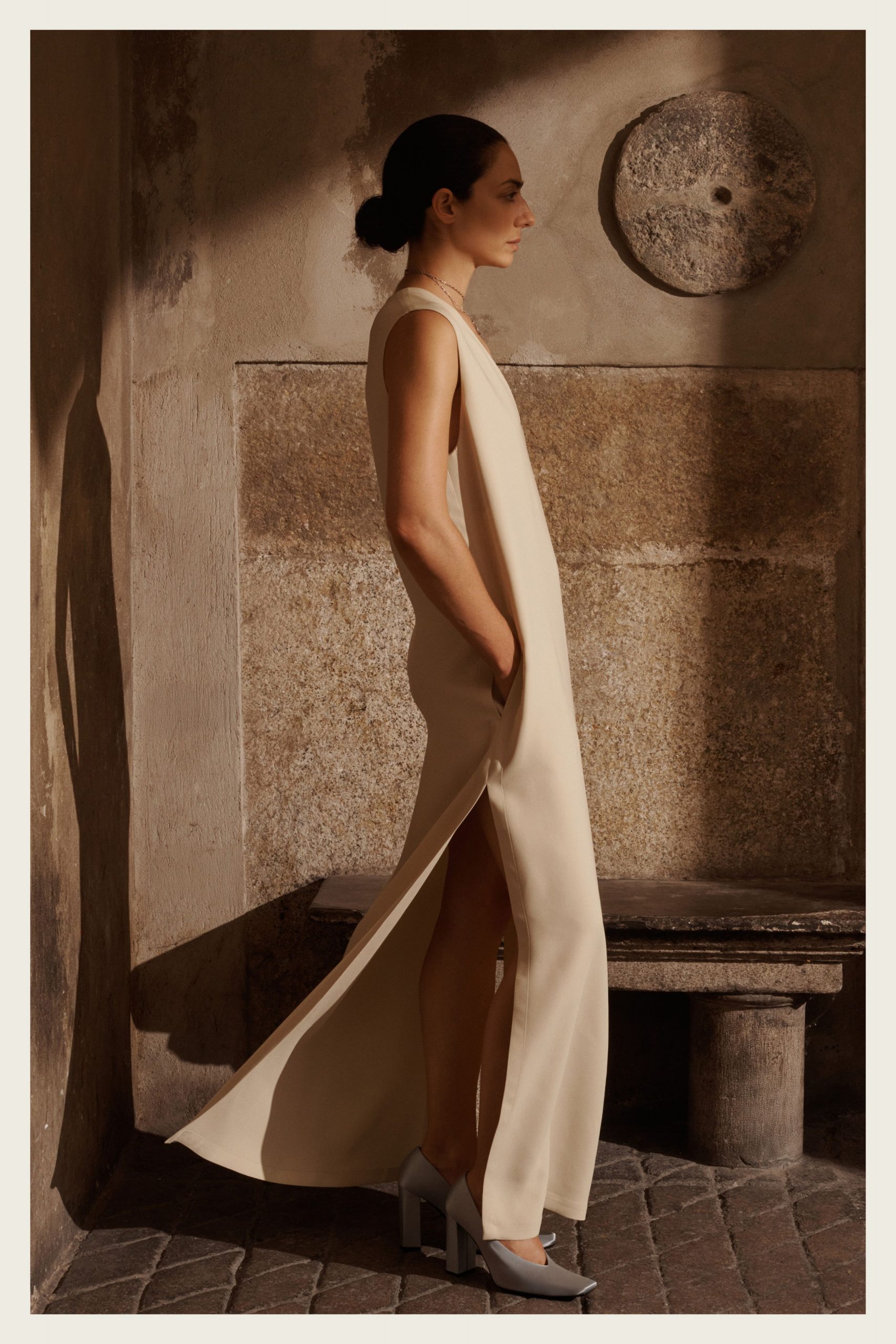 beige silk sleeveless high-neck fitted flowing maxi gown