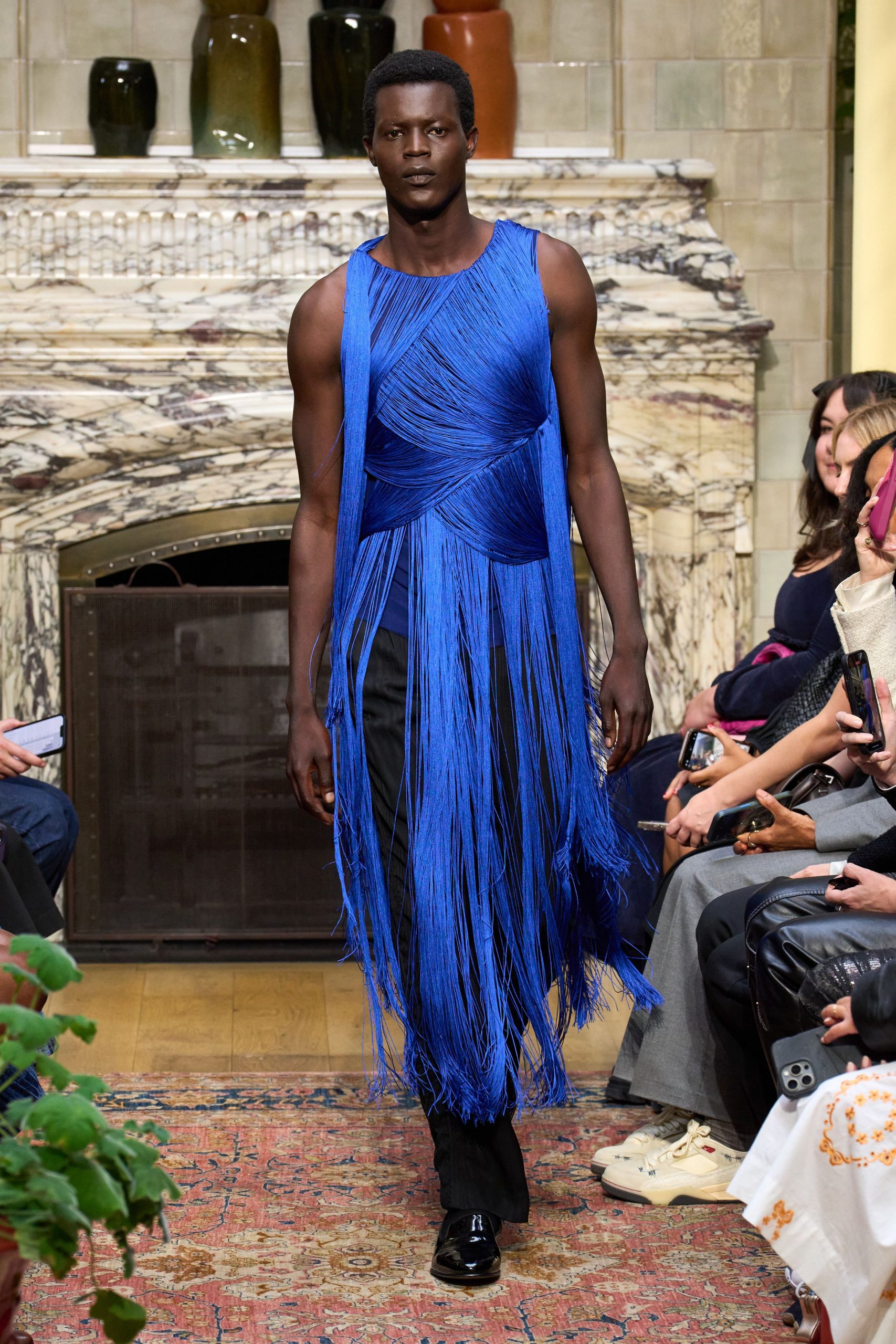 blue fringed dress with black pants